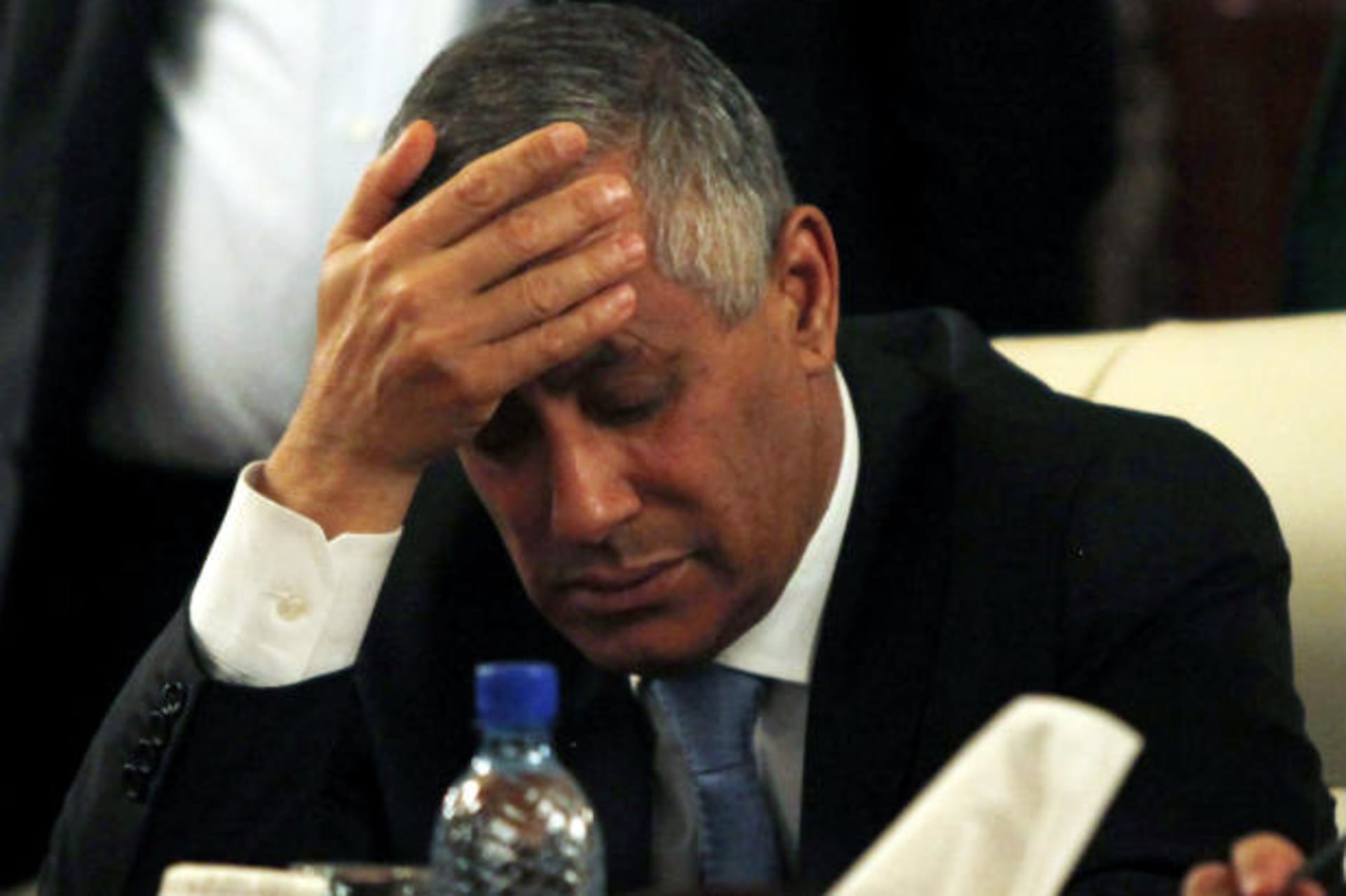 Libya's prime minister Ali Zeidan places his hand on his forehead as he addresses a news conference after his release and arrival at the headquarters of the prime minister's Office in Tripoli October 10, 2013 (Zitouny/Courtesy Reuters).