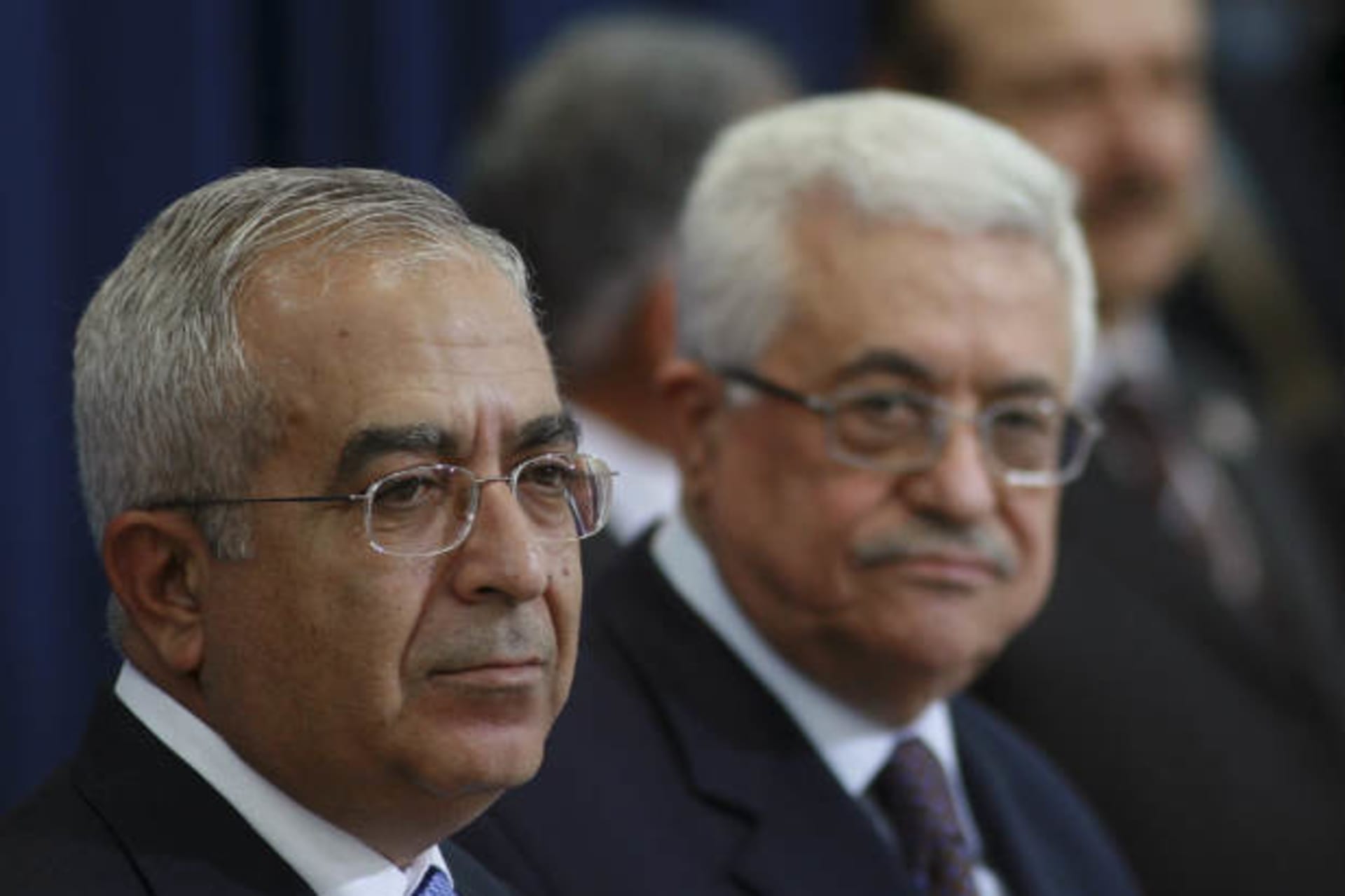 Palestinian president Mahmoud Abbas stands beside Salam Fayyad (L) during a swearing-in ceremony in the West Bank city of Ramallah May 19,2009 (Arouri/Courtesy Reuters).