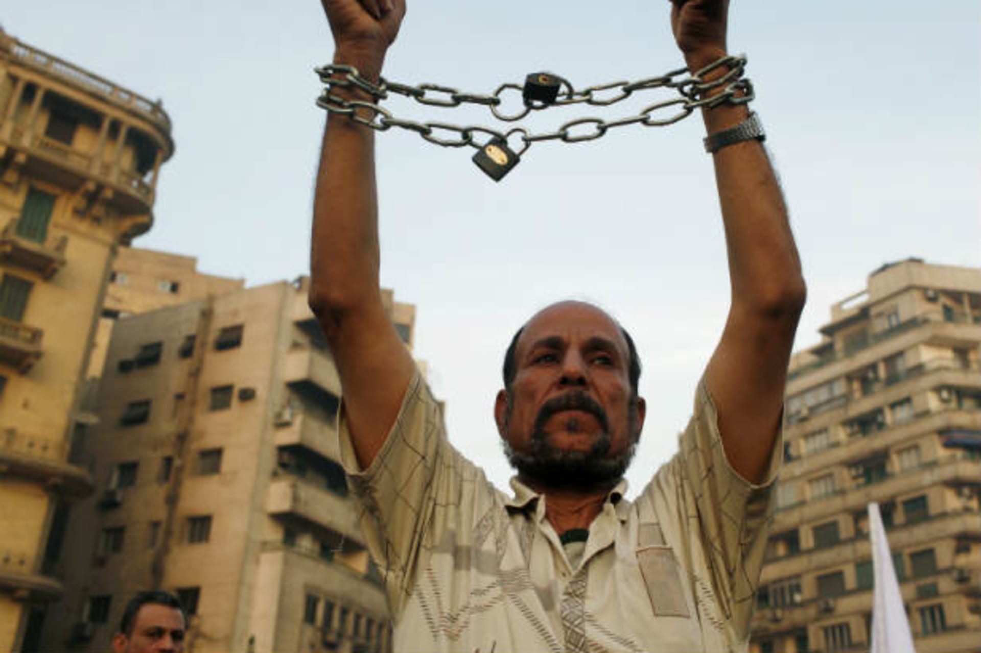 Anti-Morsi protester chains his hands during a protest in Tahrir Square in Cairo on November 30, 2012 (Waguih/Courtesy Reuters).