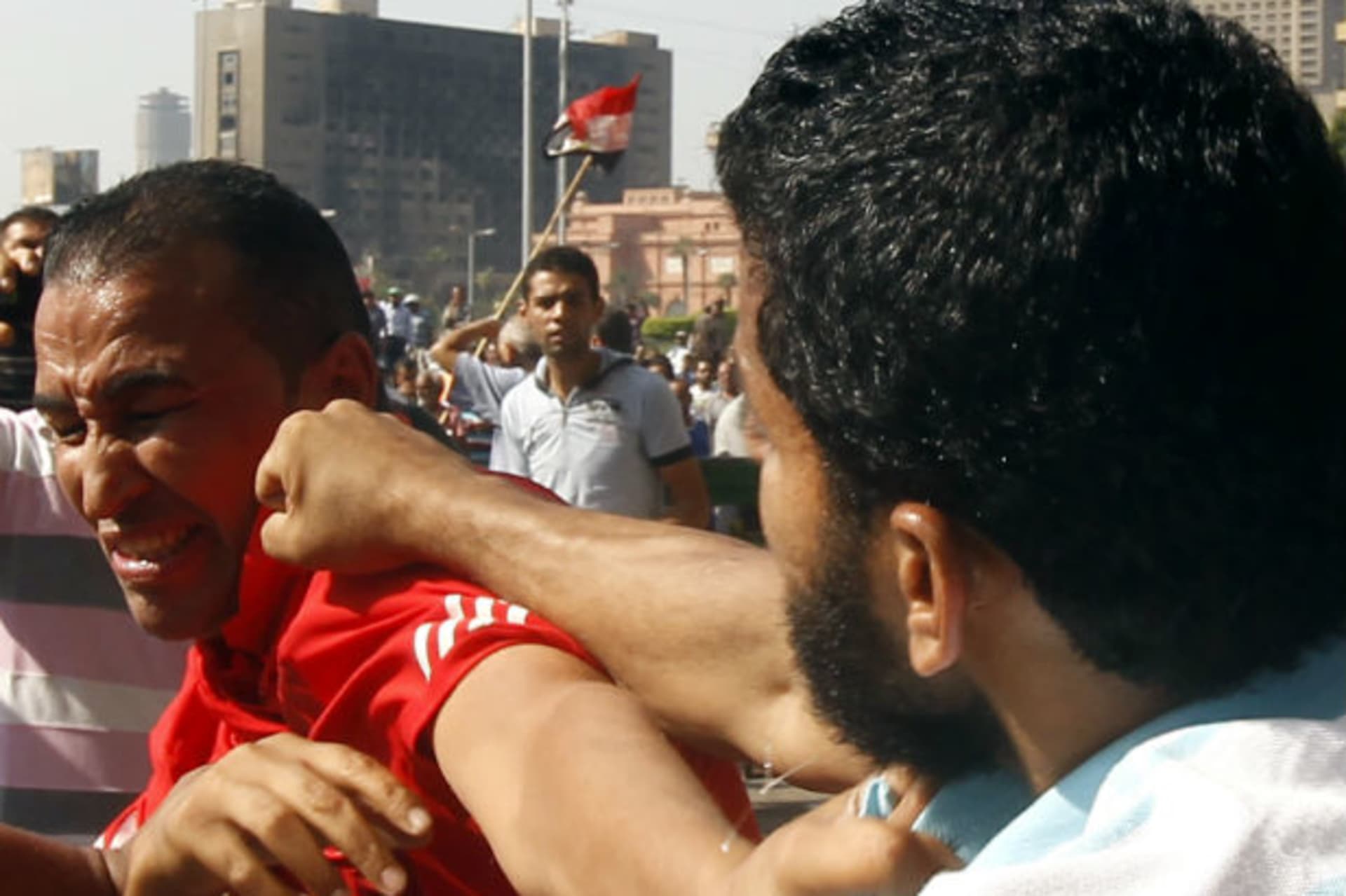 A member of the Muslim Brotherhood and supporter of Egyptian president Mohammed Morsi punches an anti-Brotherhood protester at Tahrir Square on October 12, 2012 (Chany/Courtesy Reuters).