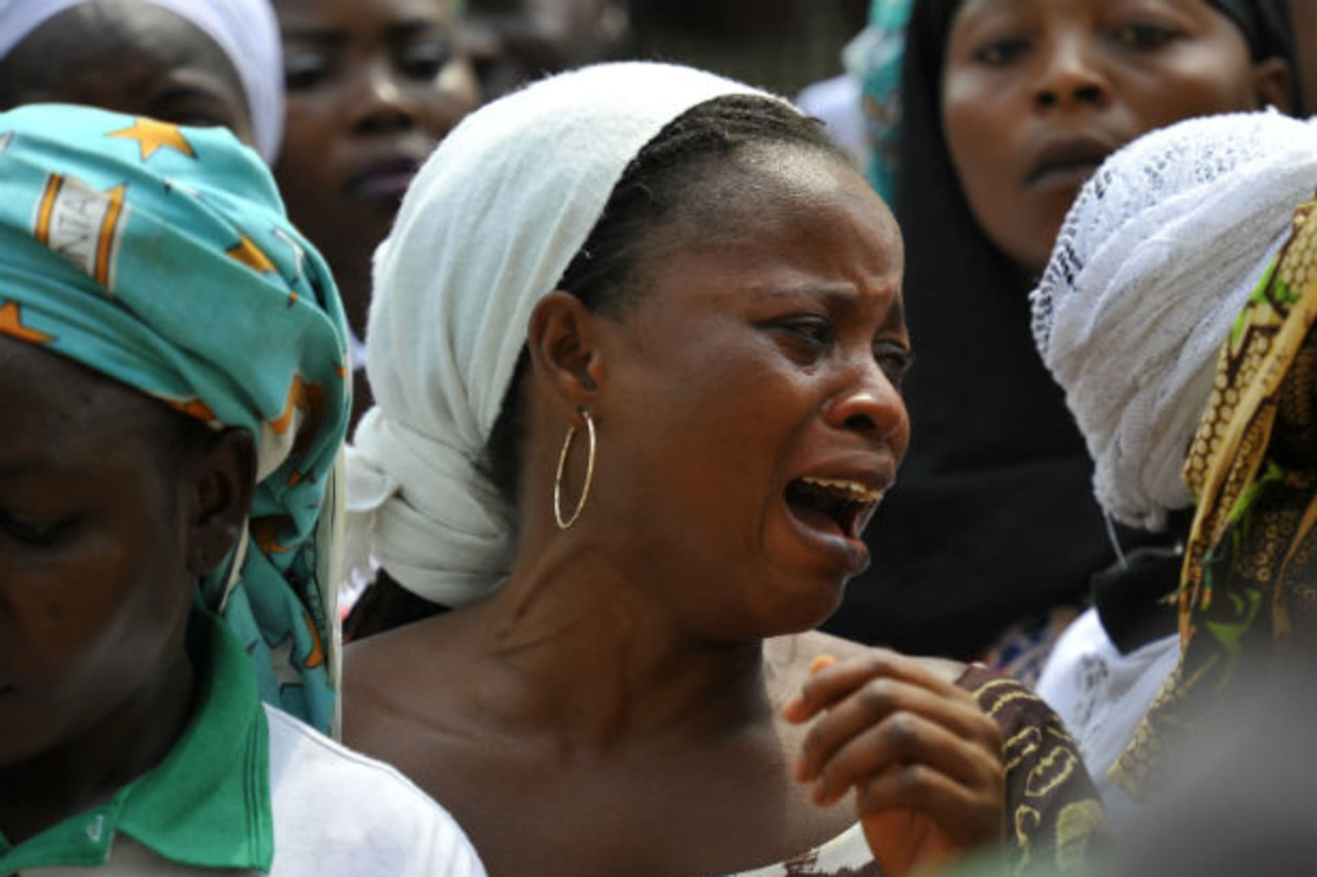 A woman cries during a mass funeral for the victims of Christmas day bombing at St Theresa Catholic church, outside Nigeria's capital Abuja 01/02/2012.