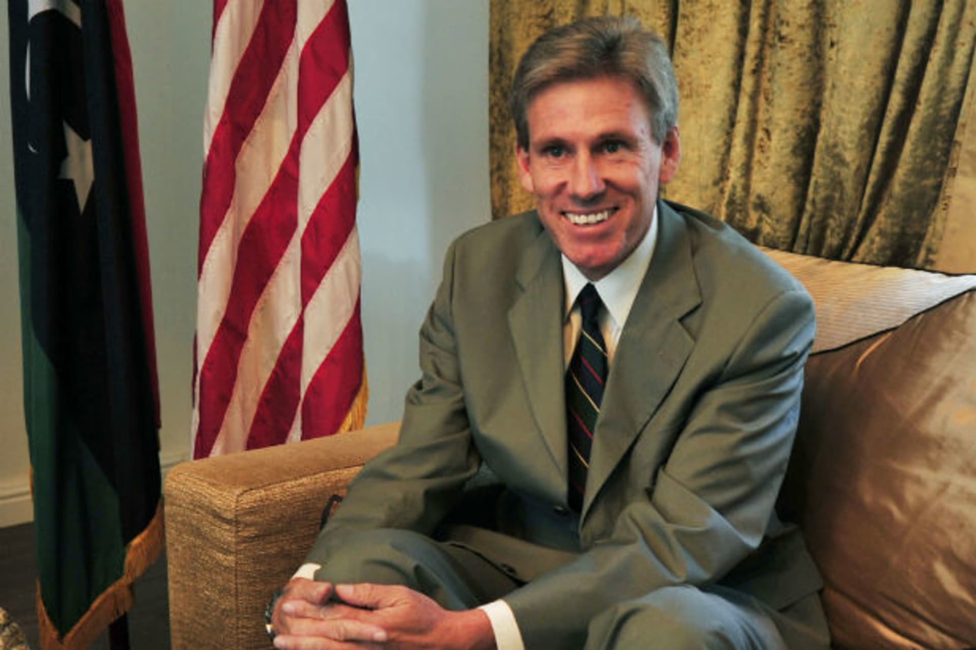 Christopher Stevens, the U.S. ambassador to Libya, smiles at his home in Tripoli on June 28, 2012 (Al-Fetori/Courtesy Reuters).