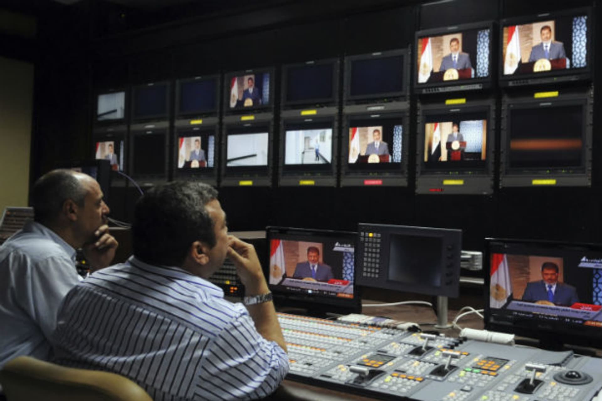 President-elect Mohamed Morsi is seen on screens at the Egyptian Television headquarters control room during his first televised address to the nation in Cairo on June 24, 2012 (Courtesy Reuters).