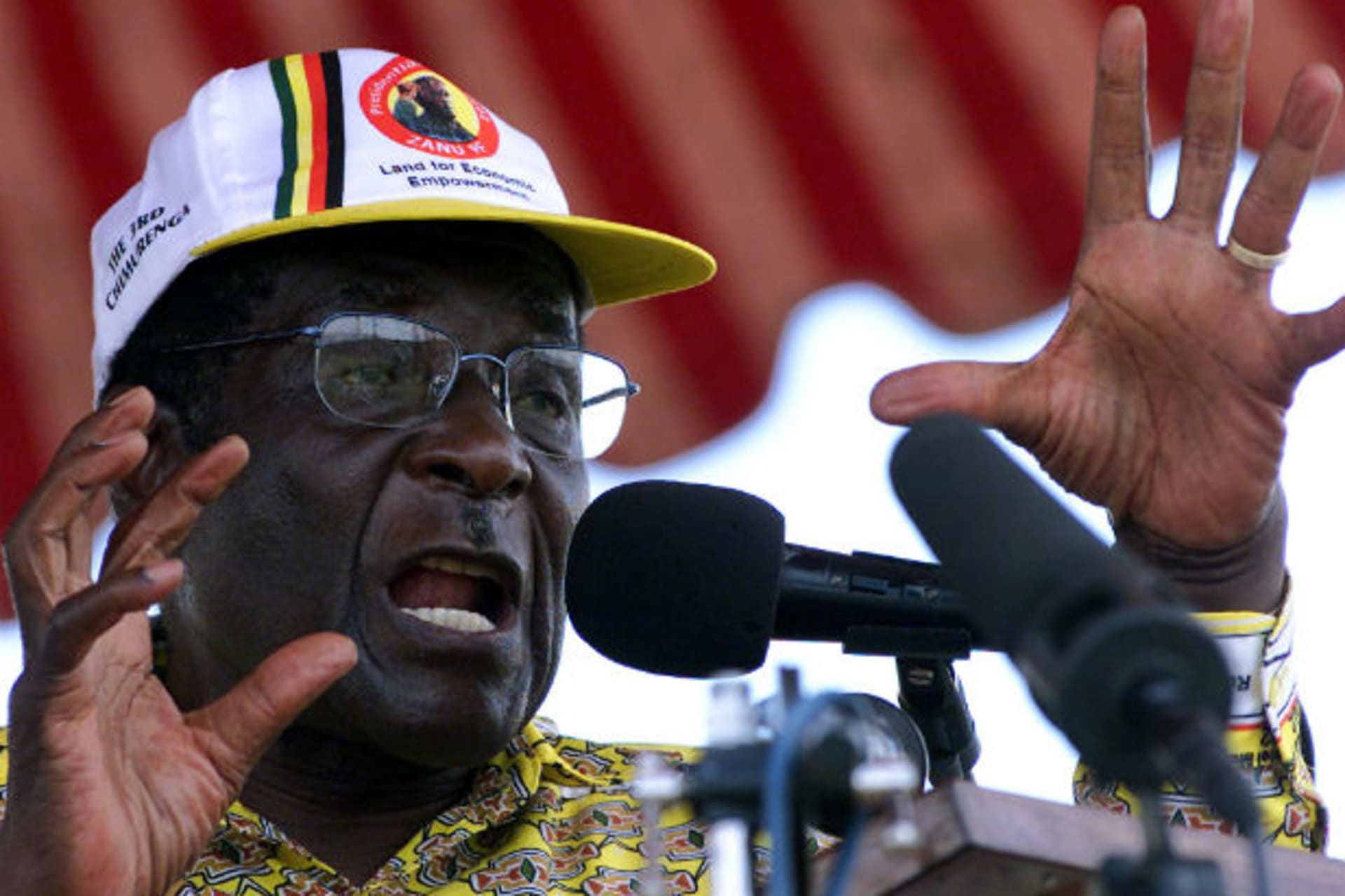Zimbabwean President Robert Mugabe arrives at a rally to address