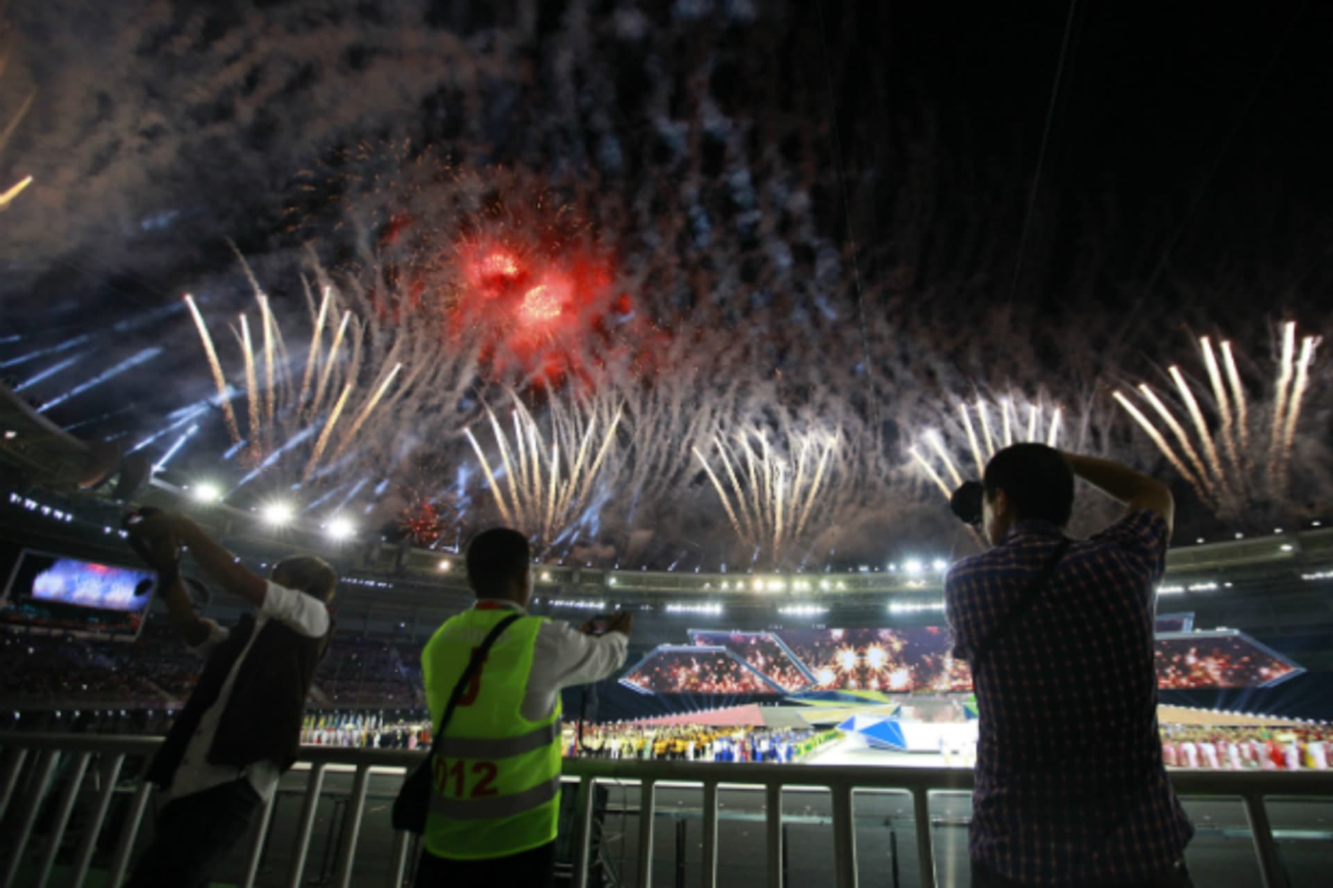 <p>People take photos as fireworks are released during the opening ceremony of the 27th SEA Games in Naypyitaw December 11, 2013. Myanmar is hosting the games for the first time in over 40 years. (Soe Zeya Tun/Courtesy Reuters)</p>