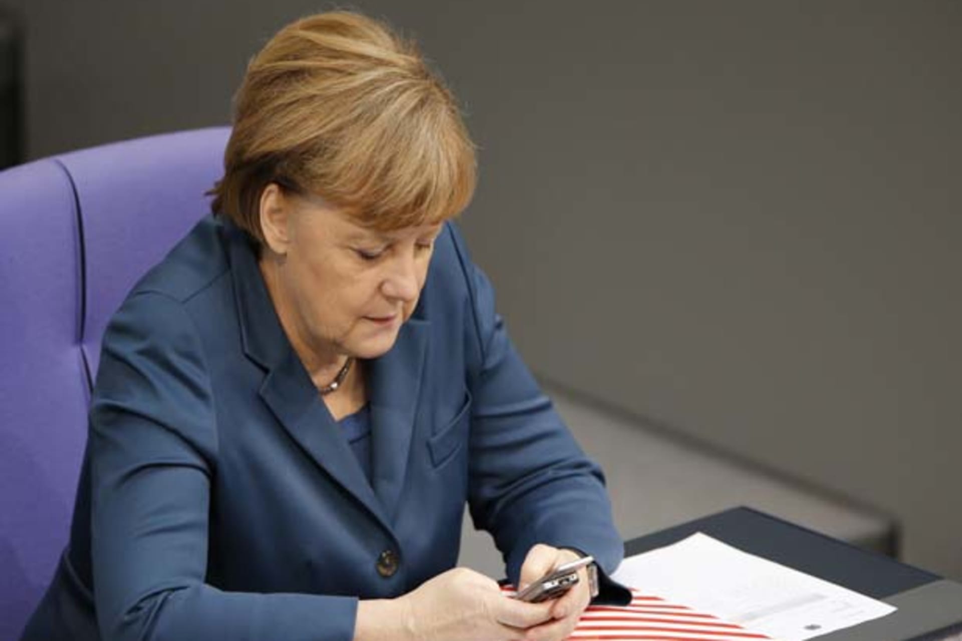 German Chancellor Merkel uses a Nokia slide mobile during a session of the lower house of parliament the Bundestag in Berlin