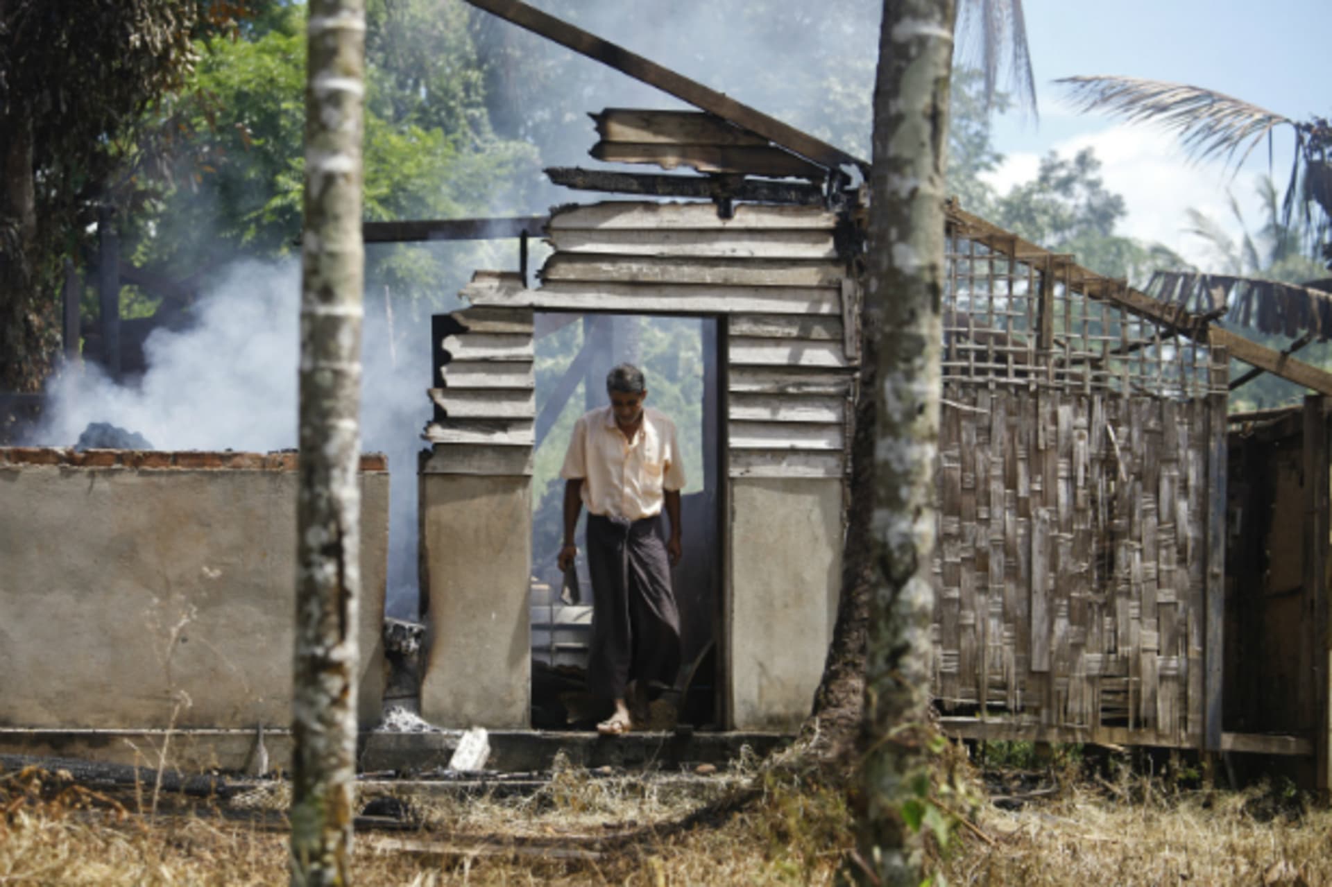 <p>A man walks out from a destroyed mosque that was burnt down in recent violence at Thapyuchai village, outside of Thandwe, in the Rakhine state, on October 3, 2013. (Soe Zeya Tun/Courtesy Reuters)</p>
