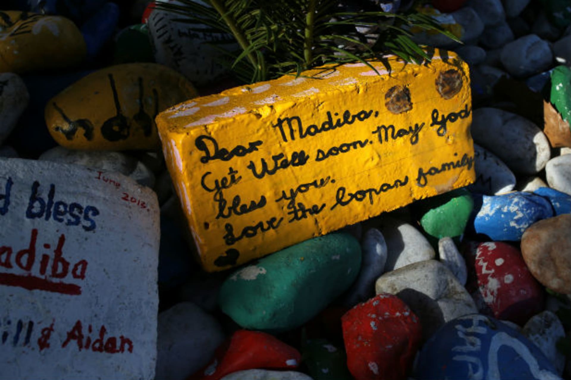 A get-well message is seen on a brick outside former South African president Nelson Mandela's garden in Houghton, Johannesburg August 31, 2013.