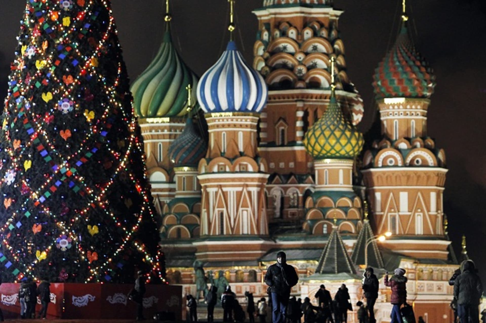 People walk along Red Square, with Saint Basil's Cathedral in the background, in central Moscow