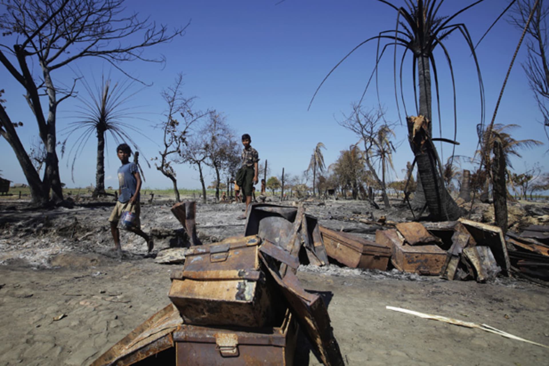 <p>People collect pieces of metal from the rubble of a neighborhood in Pauktaw township in Rakhine State, Myanmar that was burned in recent violence October 27, 2012.</p>
