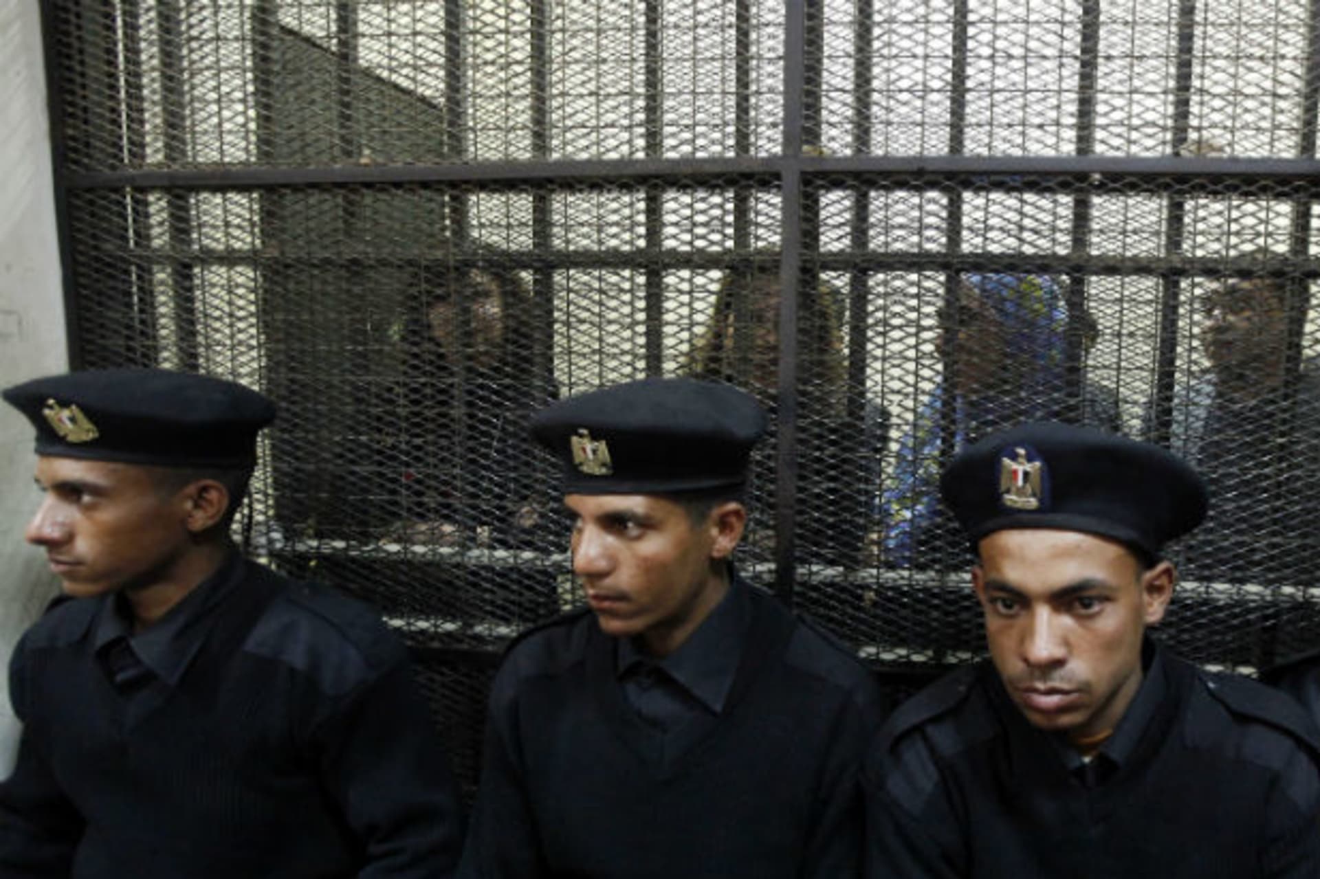 <p>Egyptian activists accused of working for outlawed non-governmental organizations stand trial in Cairo in February 2014.</p>

