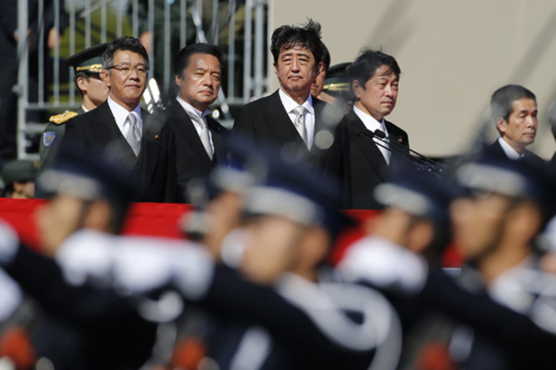 <p>Japanese Prime Minister Shinzo Abe (4th L), flanked by Defence Minister Itsunori Onodera (5th L), reviews Japan Self-Defence Forces’ (SDF) troops during the annual SDF ceremony at Asaka Base in Asaka, near Tokyo October 27, 2013</p>
