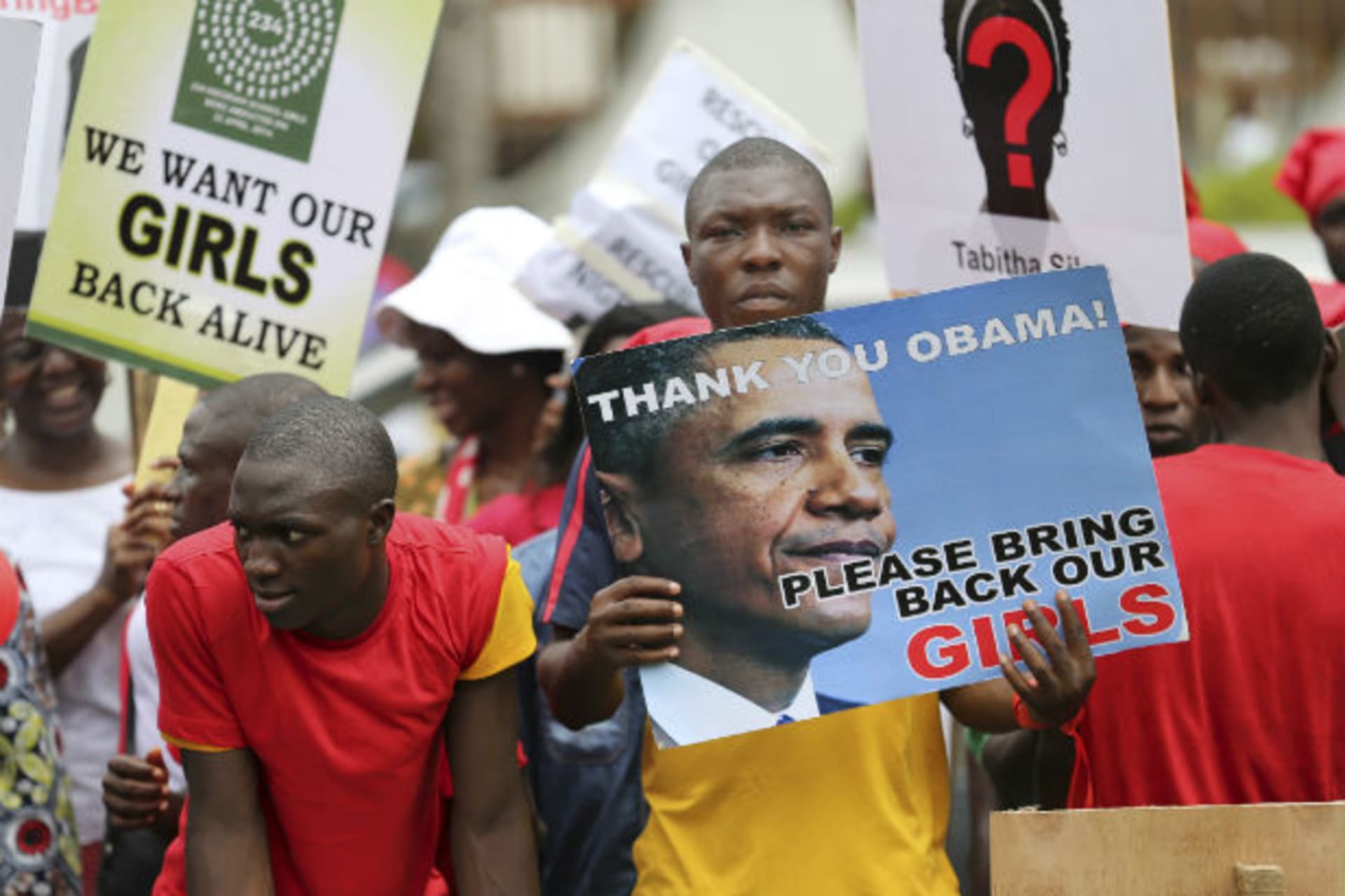 People carry signs as they attend a protest demanding the release of abducted secondary school girls in the remote village of Chibok, in Lagos May 9, 2014.