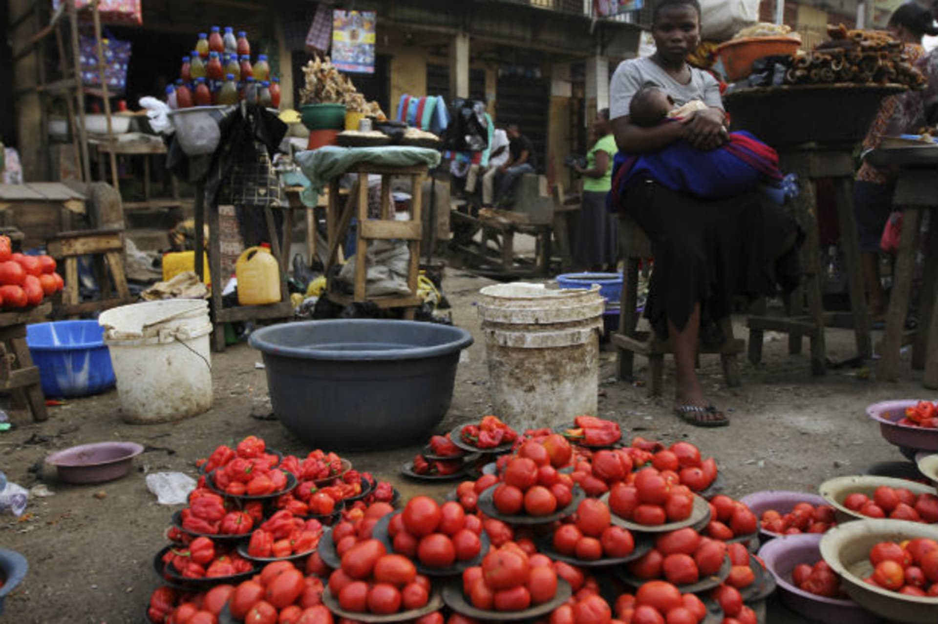 A woman waits for customer at a local food market after the suspension of a nationwide strike by labour unions, in Nigeria's commercial capital Lagos January 16, 2012.