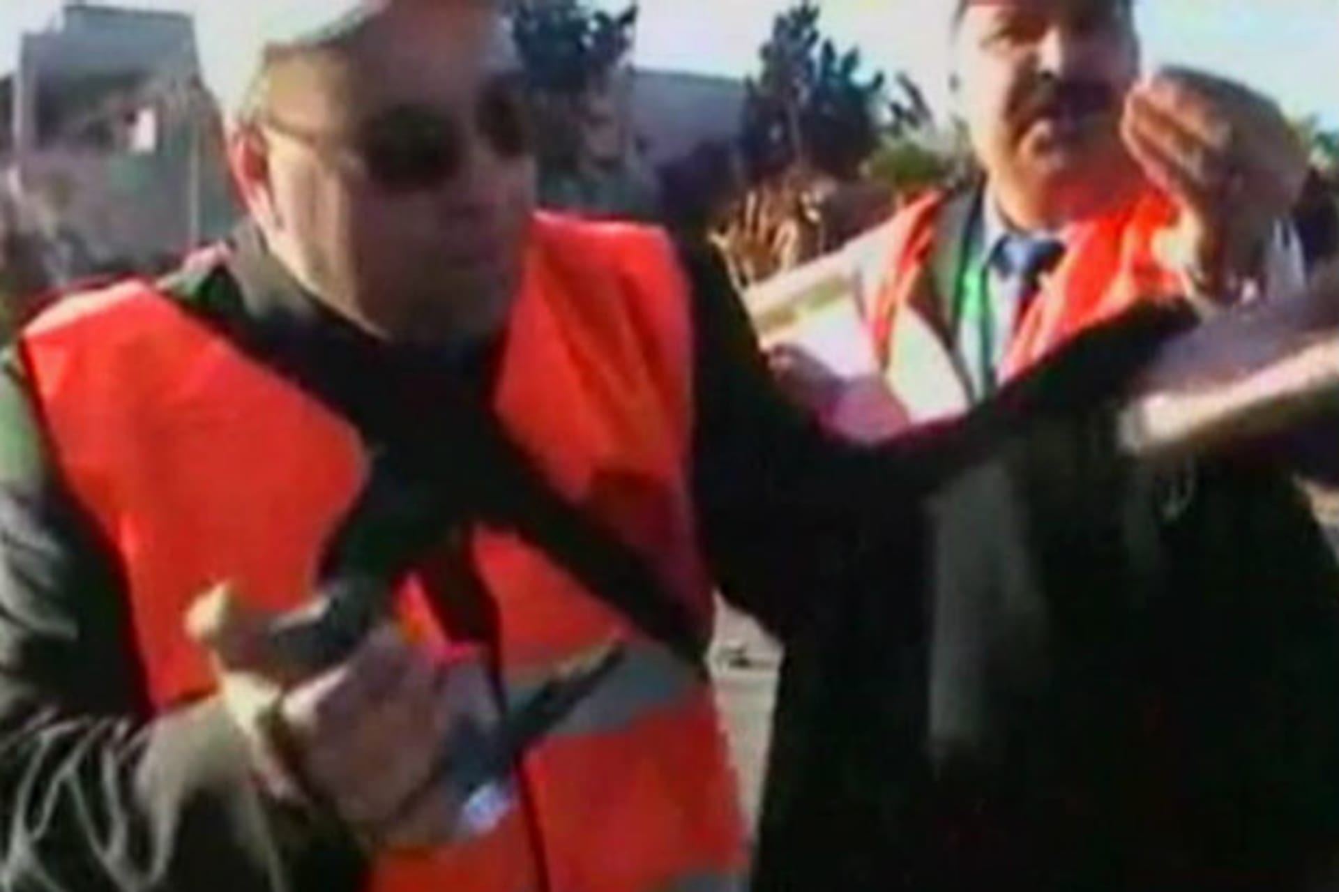 This still image taken from video uploaded to a social media website on December 28, 2011 shows Arab League monitors speak to the camera after seeing the body of a dead boy claimed to have been killed by Syrian security forces in what is purpor