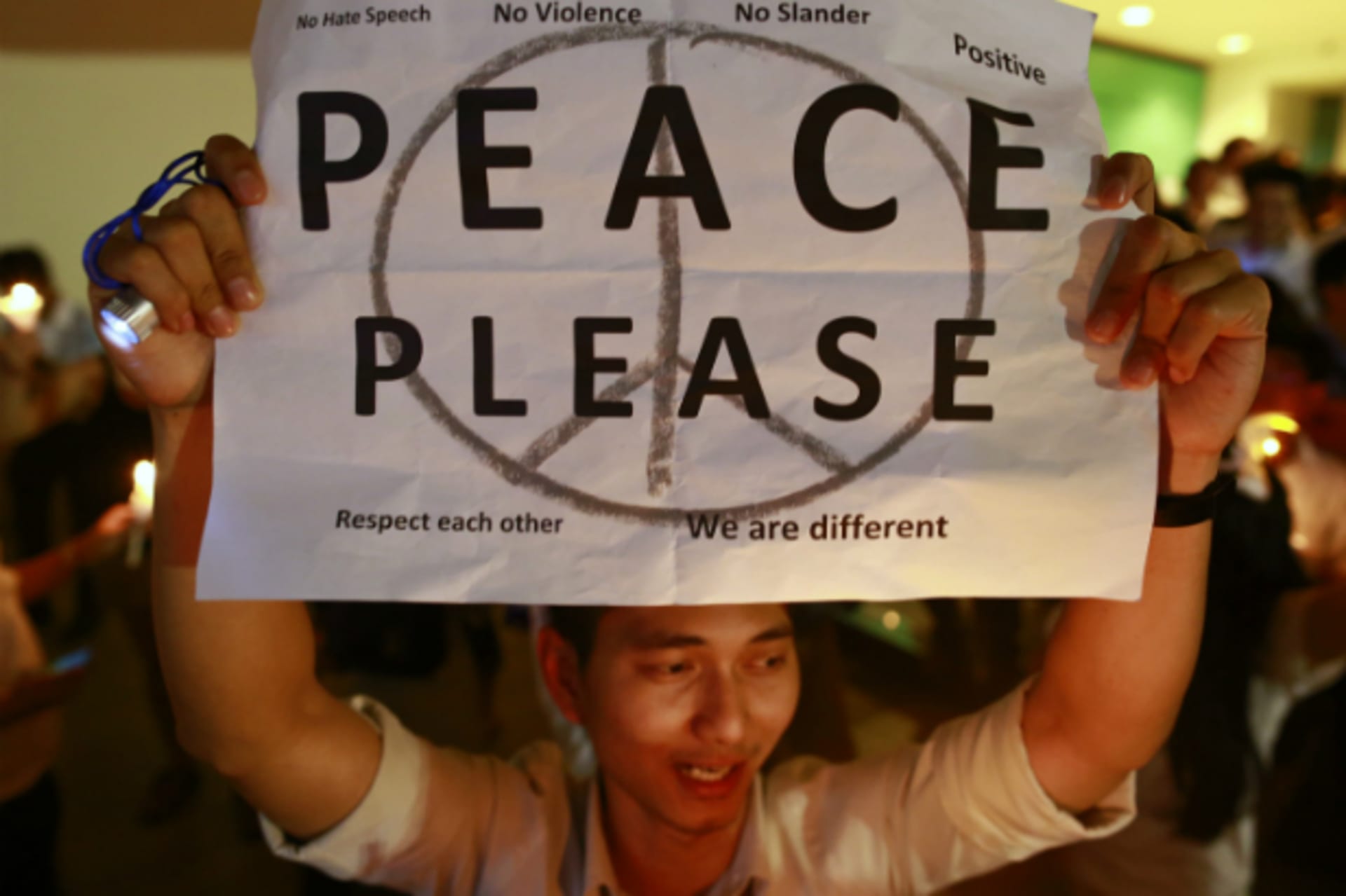 <p>A man holds up a poster during an anti-violence campaign in central Bangkok on January 10, 2014.(Soe Zeya Tun/Courtesy Reuters)</p>
