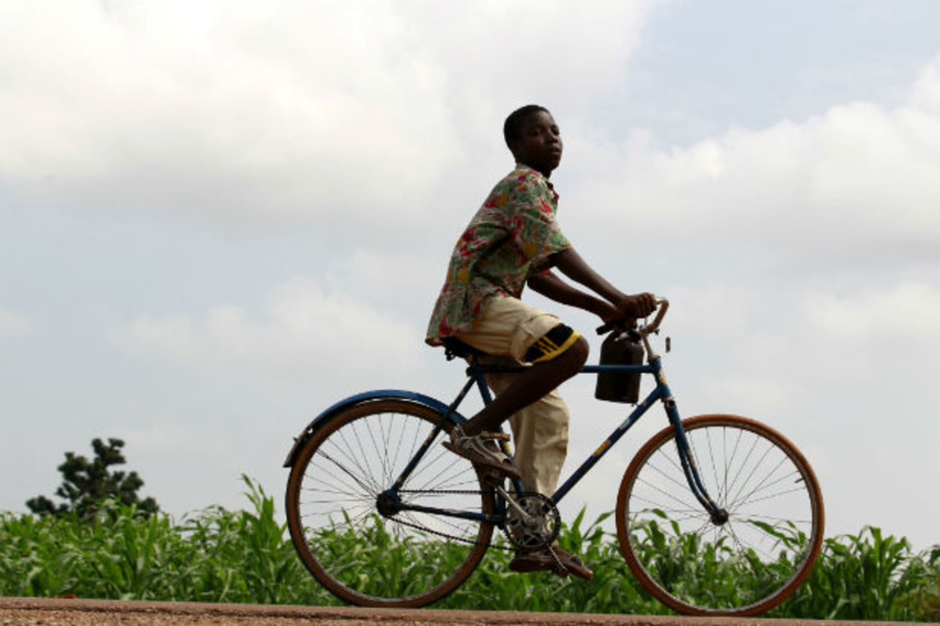 A youth rides past a bicycle along Anka-Sokoto road in northeastern state of Zamfara August 13, 2013.