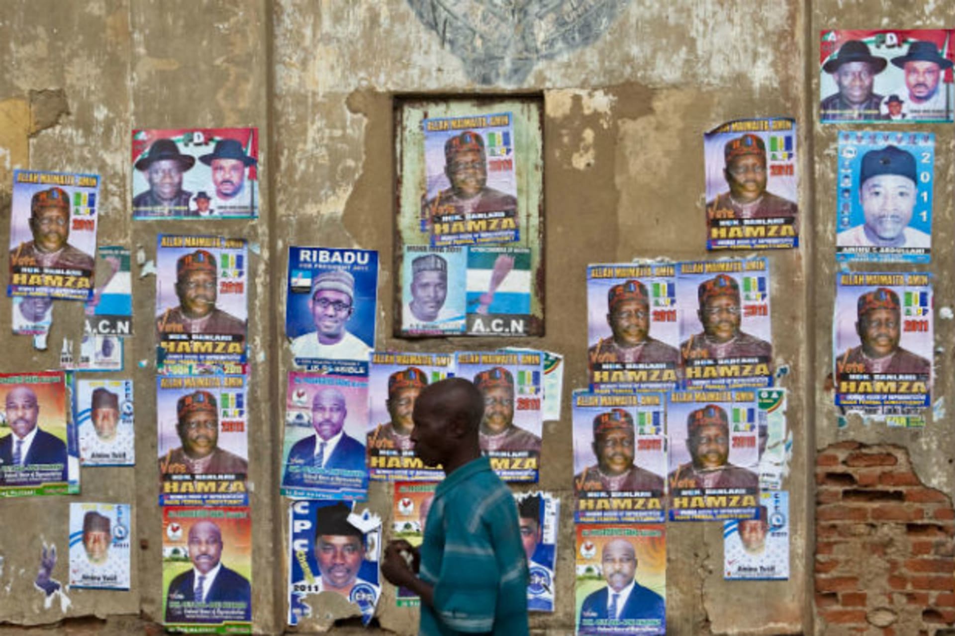 A man walks past election campaign posters in Kano, northern Nigeria, April 1, 2011.