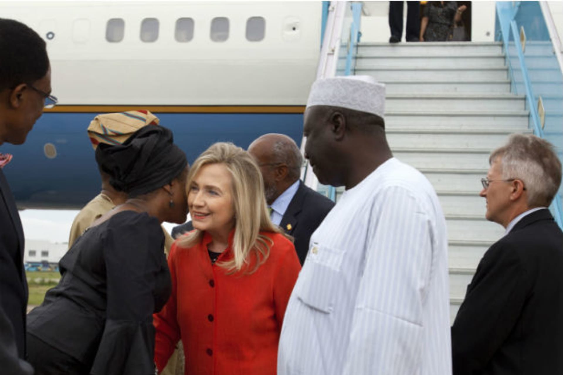 Nigeria's Minister of State for Foreign Affairs Viola Onwuliri (2nd L) greets U.S. Secretary of State Hillary Clinton as she arrives at Abuja International Airport in Abuja August 9, 2012.