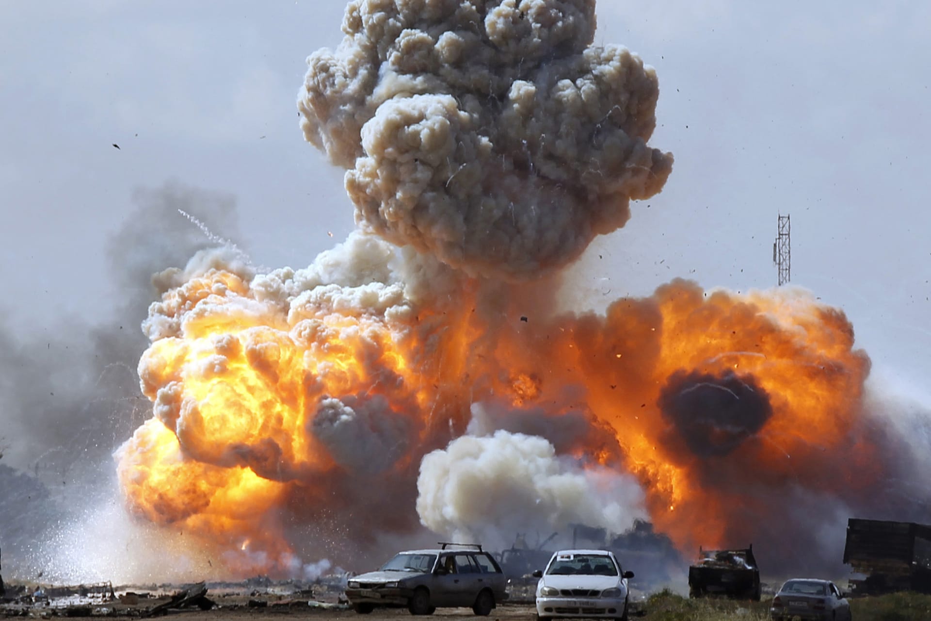 <p>Vehicles belonging to Qaddafi forces explode after an air strike by coalition planes along a road between Benghazi and Ajdabiya on March 20, 2011. Goran Tomasevic/Reuters</p>
