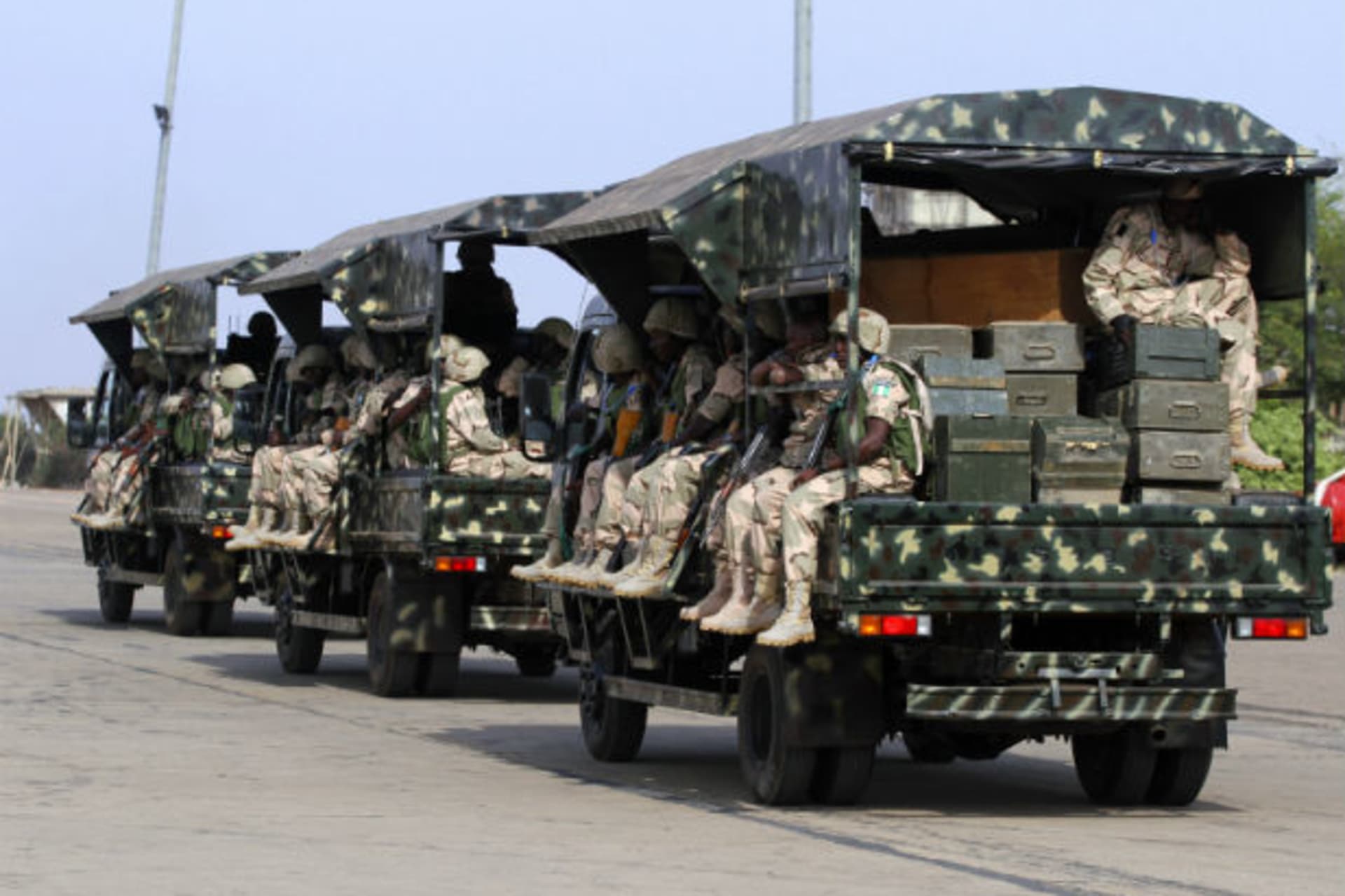 Nigerian soldiers sit in military trucks before leaving for Mali, at the airport in Nigeria's northern state of Kaduna January 17, 2013.