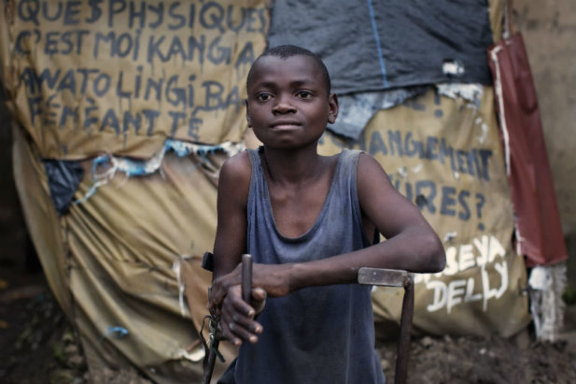 Arnaud Bivilia, 12, who suffers from polio, stands at the Stand Proud compound in Kinshasa November 29, 2011.
