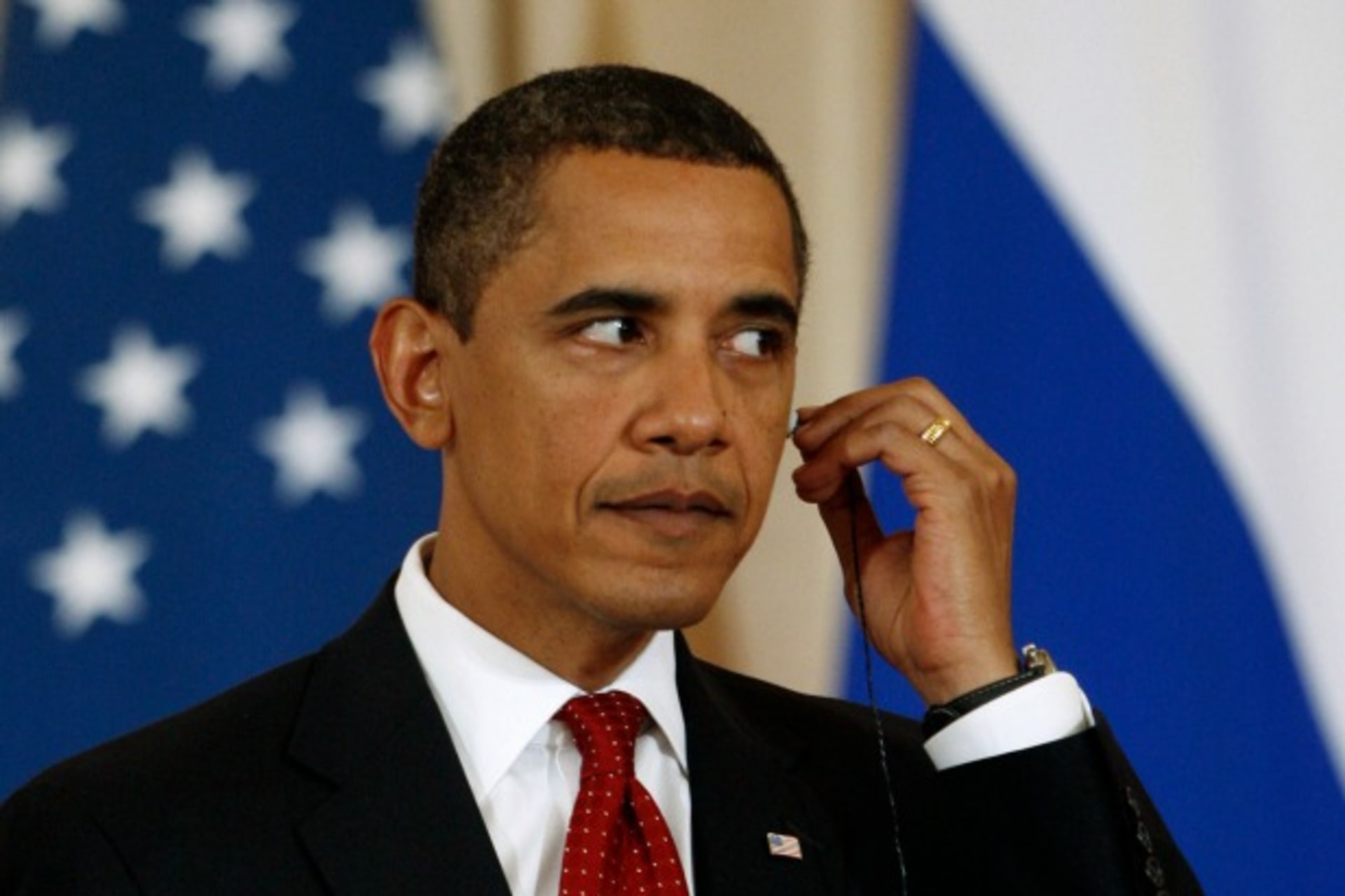 <p>U.S. President Barack Obama adjusts his translators ear piece.</p>
