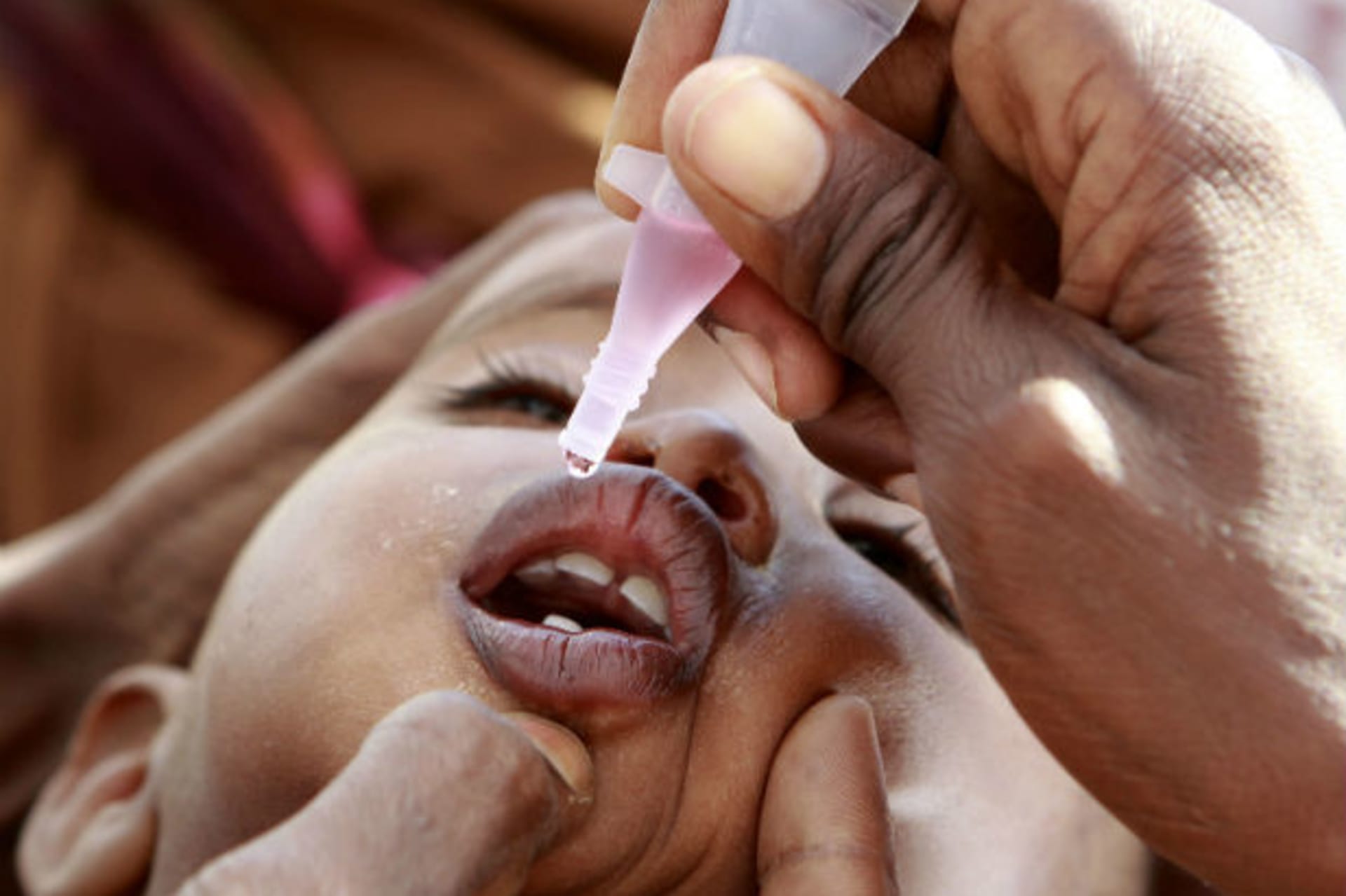 A newly arrived Somali refugee child receives a polio drop at the Ifo extension refugee camp in Dadaab, near the Kenya-Somalia border, August 1, 2011.