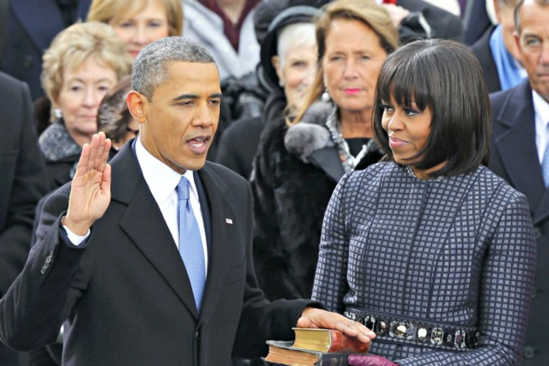 <p>U.S. President Barack Obama recites his oath of office as first lady Michelle Obama looks on during swearing-in ceremonies on the West front of the U.S Capitol in Washington, DC, on January 21, 2013.</p>