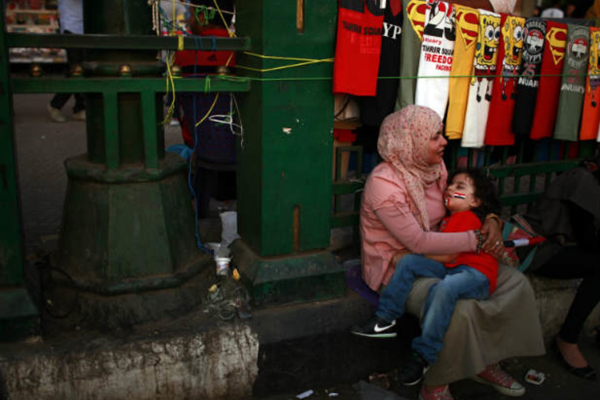 An Egyptian woman holds her son during a demonstration at Tahrir square in Cairo (Salem/Courtesy Reuters).