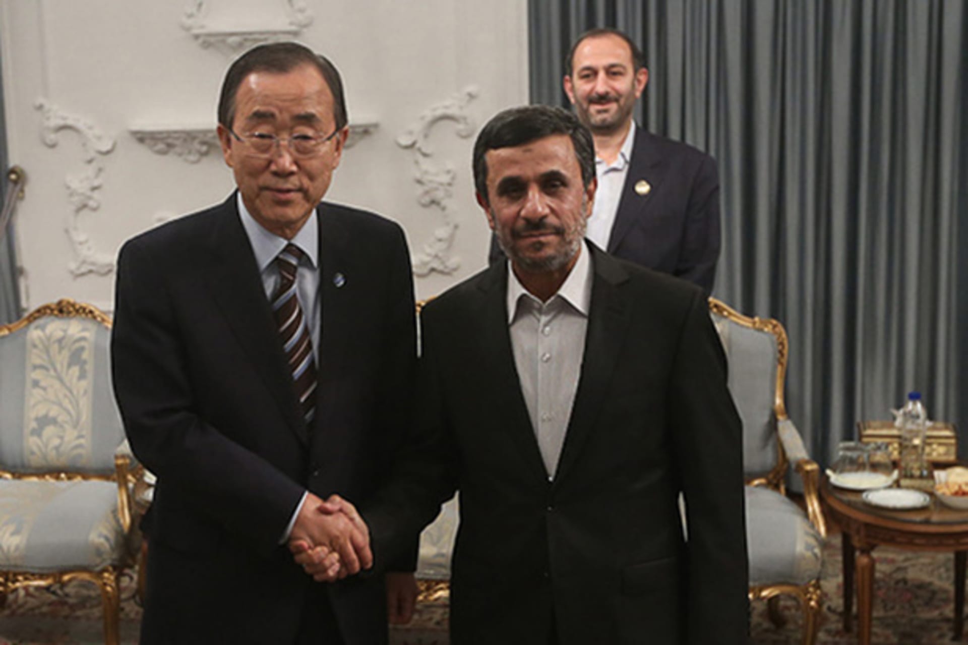 United Nations Secretary-General Ban Ki-moon poses for a photo with Iran's President Ahmadinejad upon his arrival for 16th summit of Non-Aligned Movement in Tehran