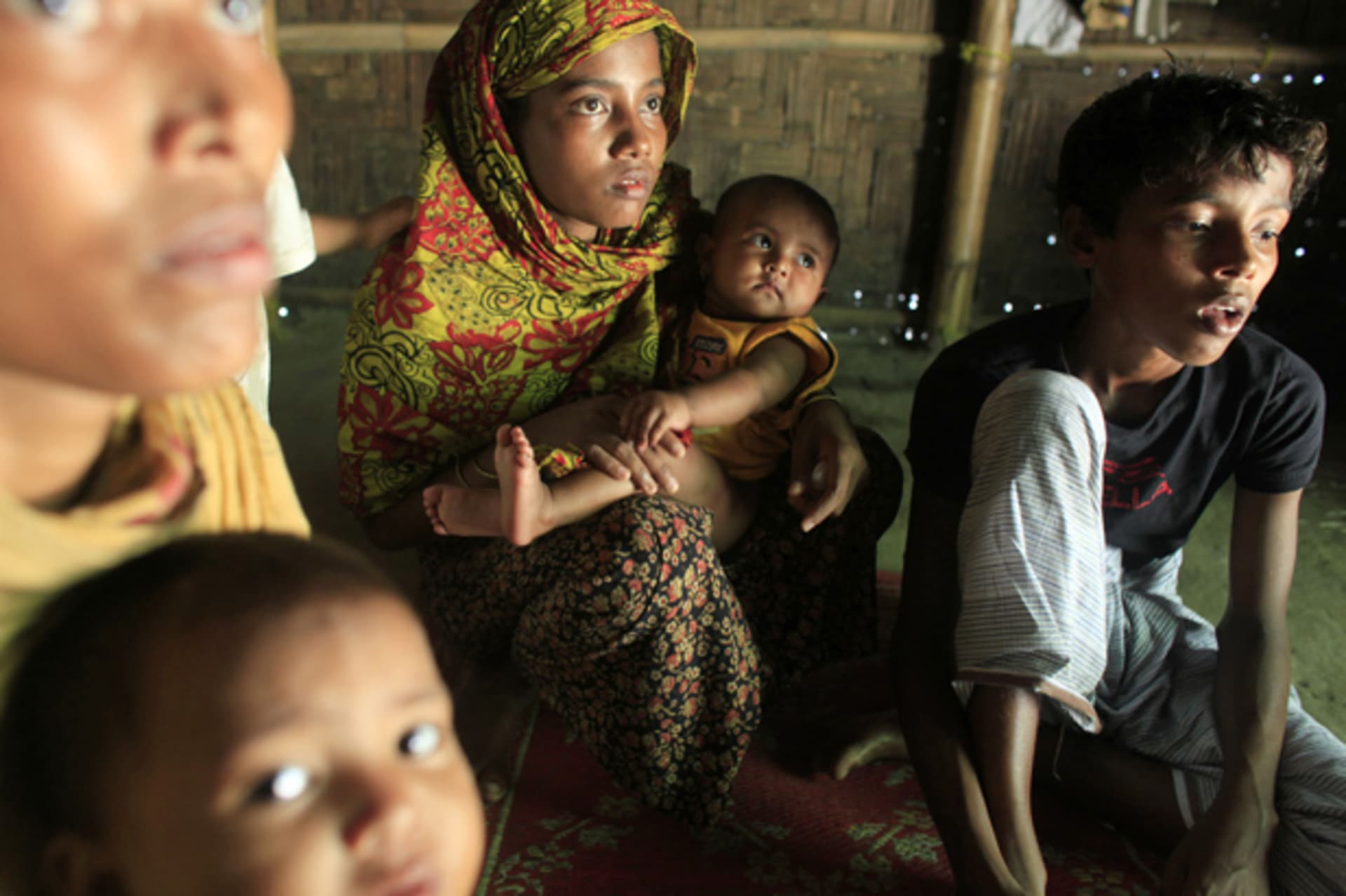 Rohingya women and children hide in a house in Teknaf
