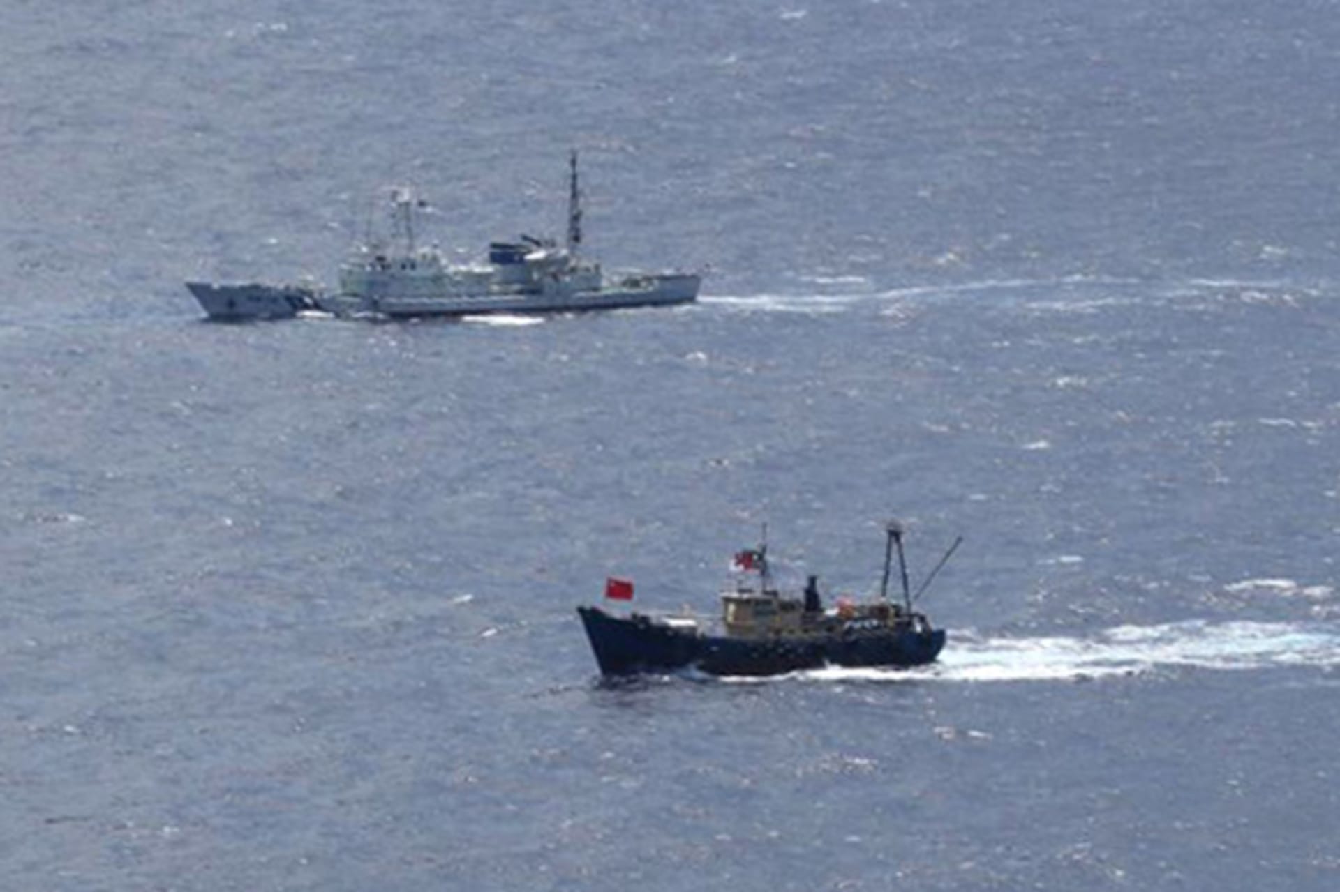 <p>A Japan Coast Guard patrol ship sails around a Hong Kong fishing boat near the disputed islands in the East China Sea, known as Senkaku in Japan or Diaoyu in China</p>
