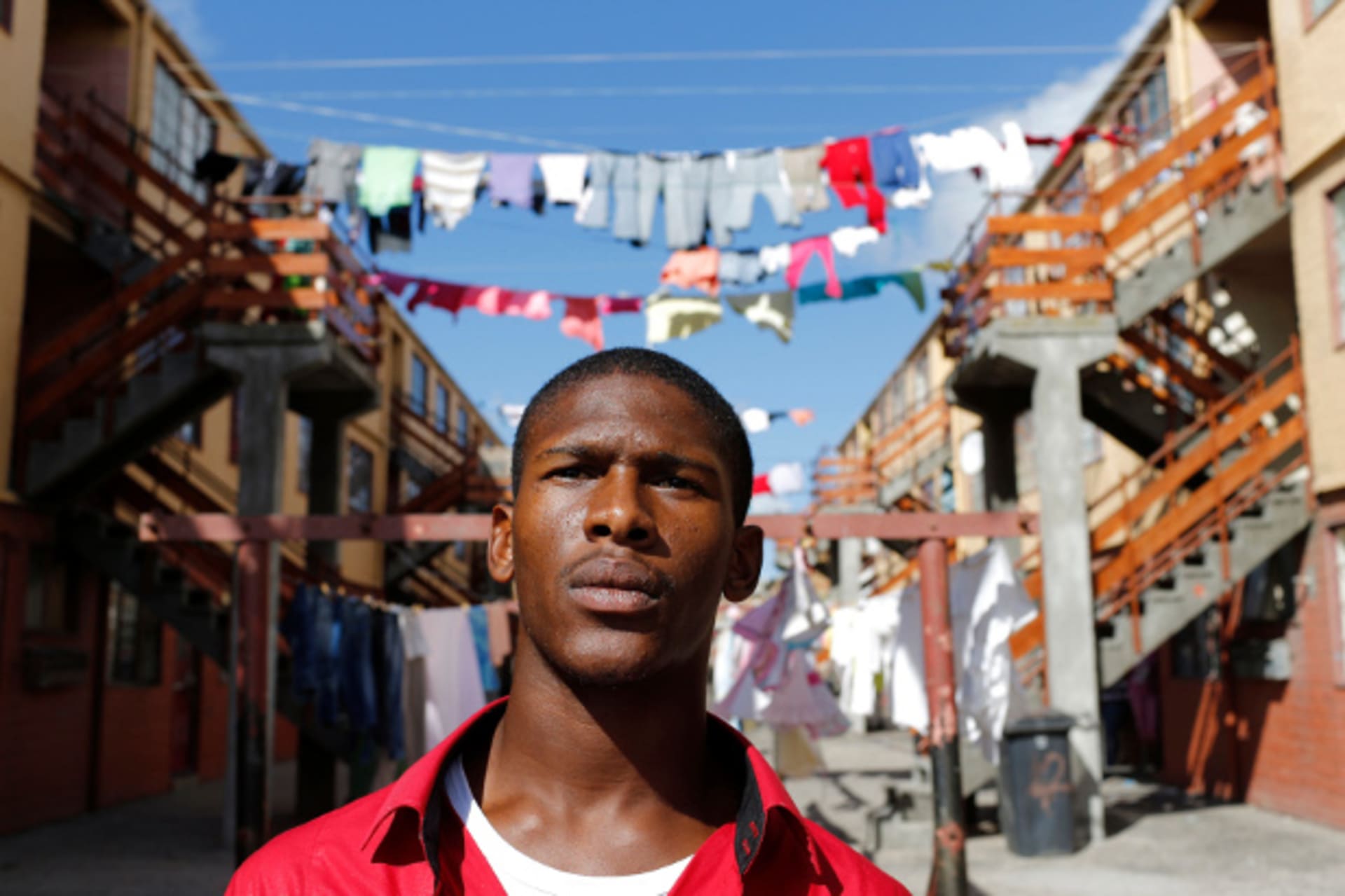 Youth worker Nathaniel Groep, 19, stands in front of flats outside his home in Mannenberg, a gang-ravaged township, in Cape Town April 18, 2014. Nathaniel said, "Every vote counts, particularly for young people. For our generation there are new