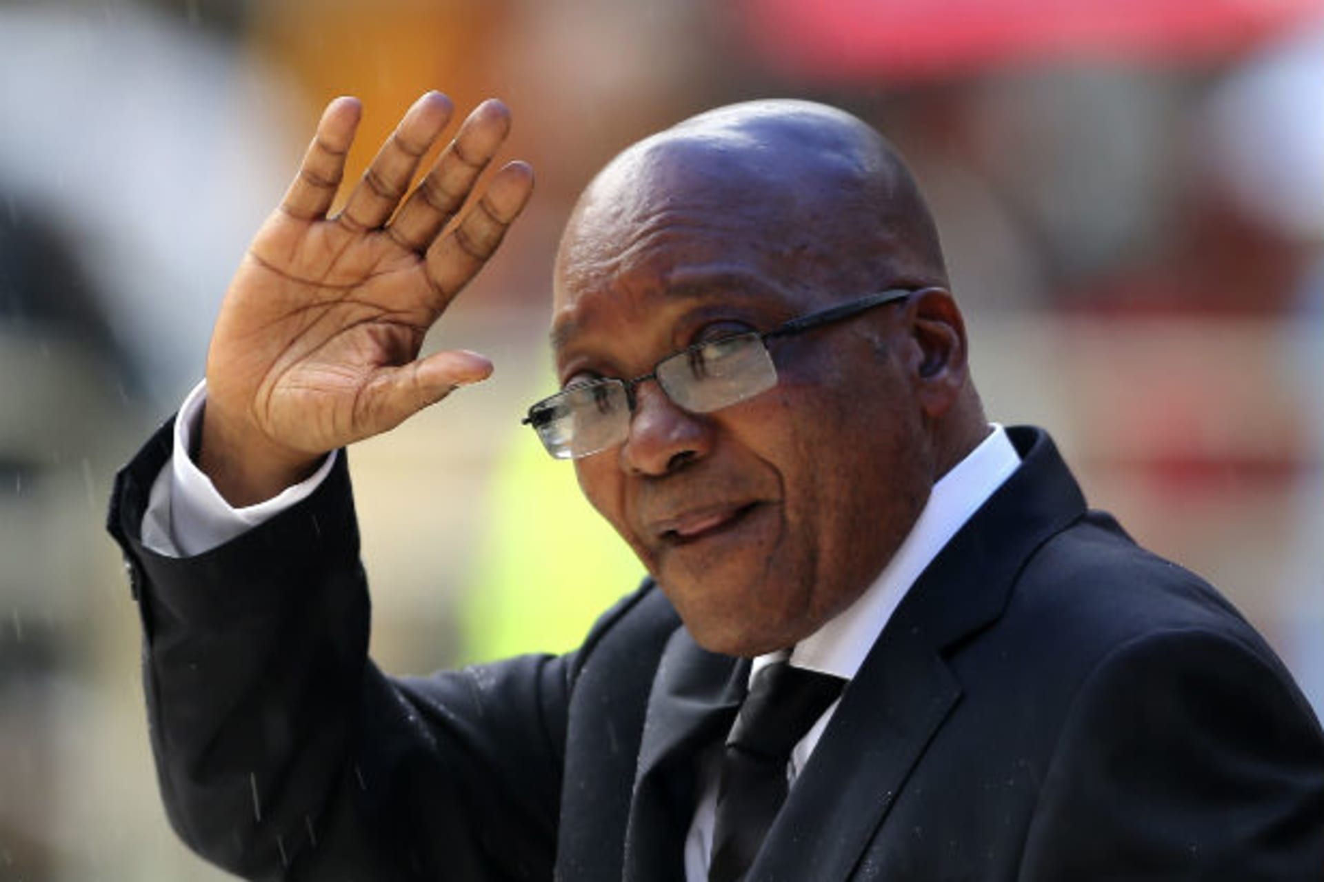 December 10, 2013South African President Jacob Zuma waves as he arrives at the First National Bank (FNB) Stadium, also known as Soccer City, ahead of the national memorial service for late former South African President Nelson Mandela in Johann