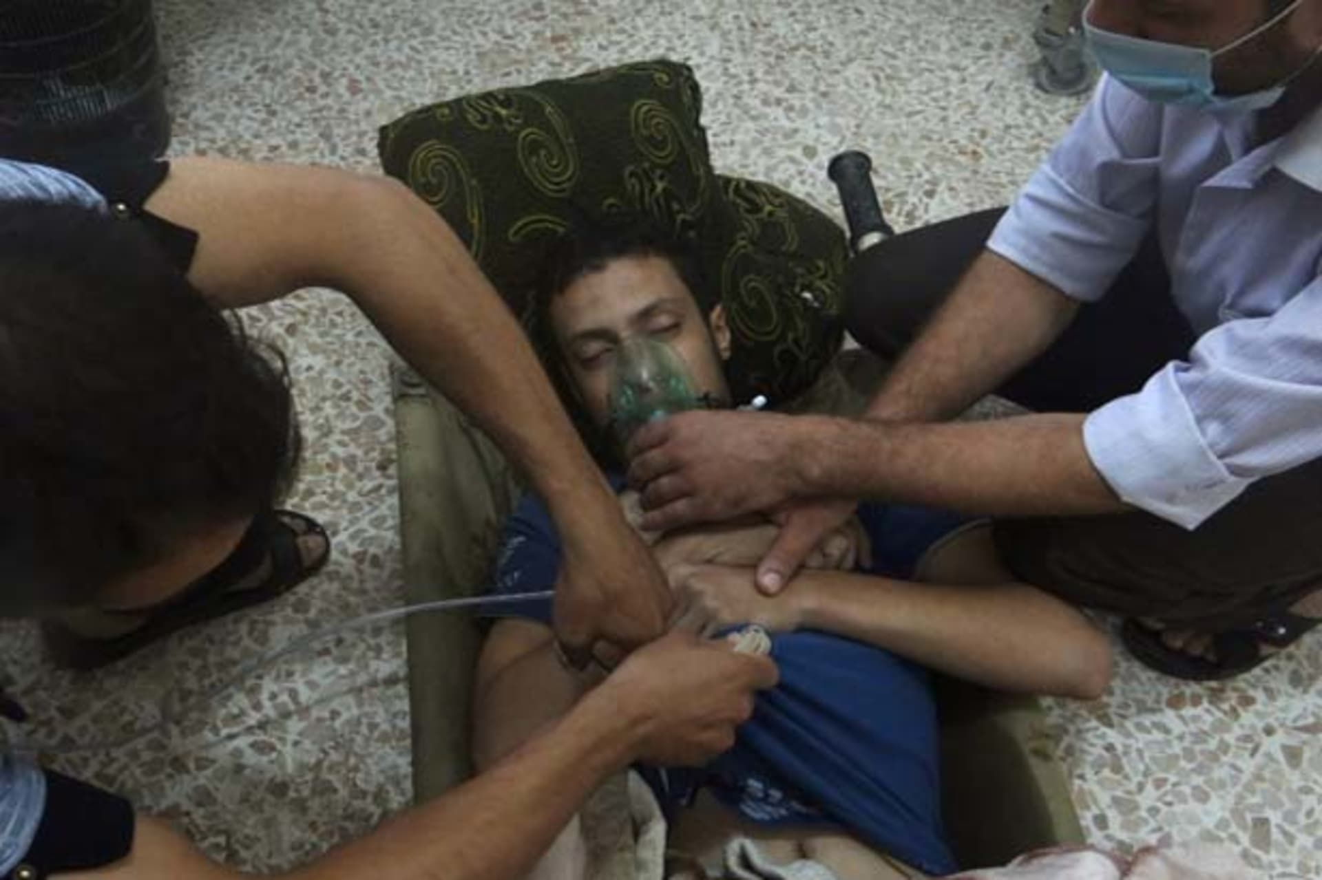 A man, affected by what activists say is nerve gas, breathes through an oxygen mask in the Damascus suburbs of Jesreen