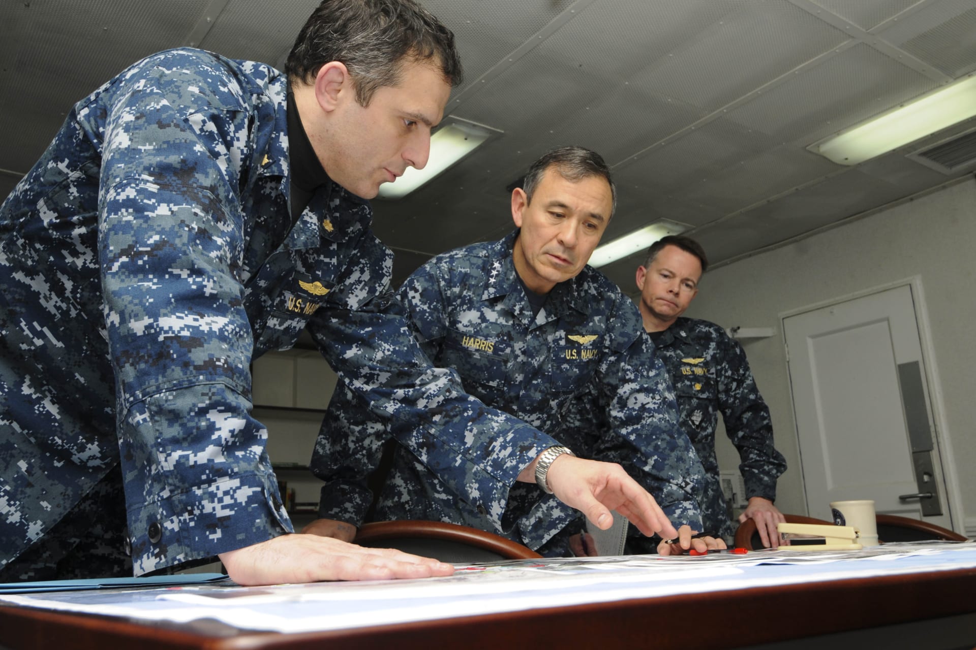 <p>Vice Adm. Harry B. Harris Jr. receives an overnight situation report aboard the command ship USS Mount Whitney on March 24, 2011. REUTERS</p>
