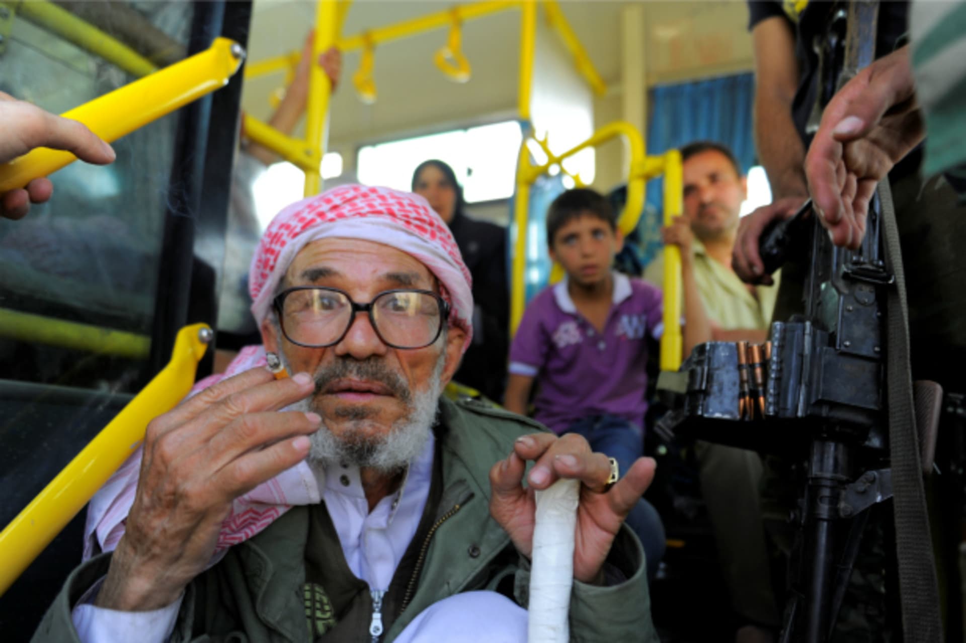 <p>People ride a bus to be evacuated from the besieged Damascus suburb of Daraya, after an agreement reached on Thursday between rebels and Syria’s army (Omar Sanadiki/Reuters).</p>
