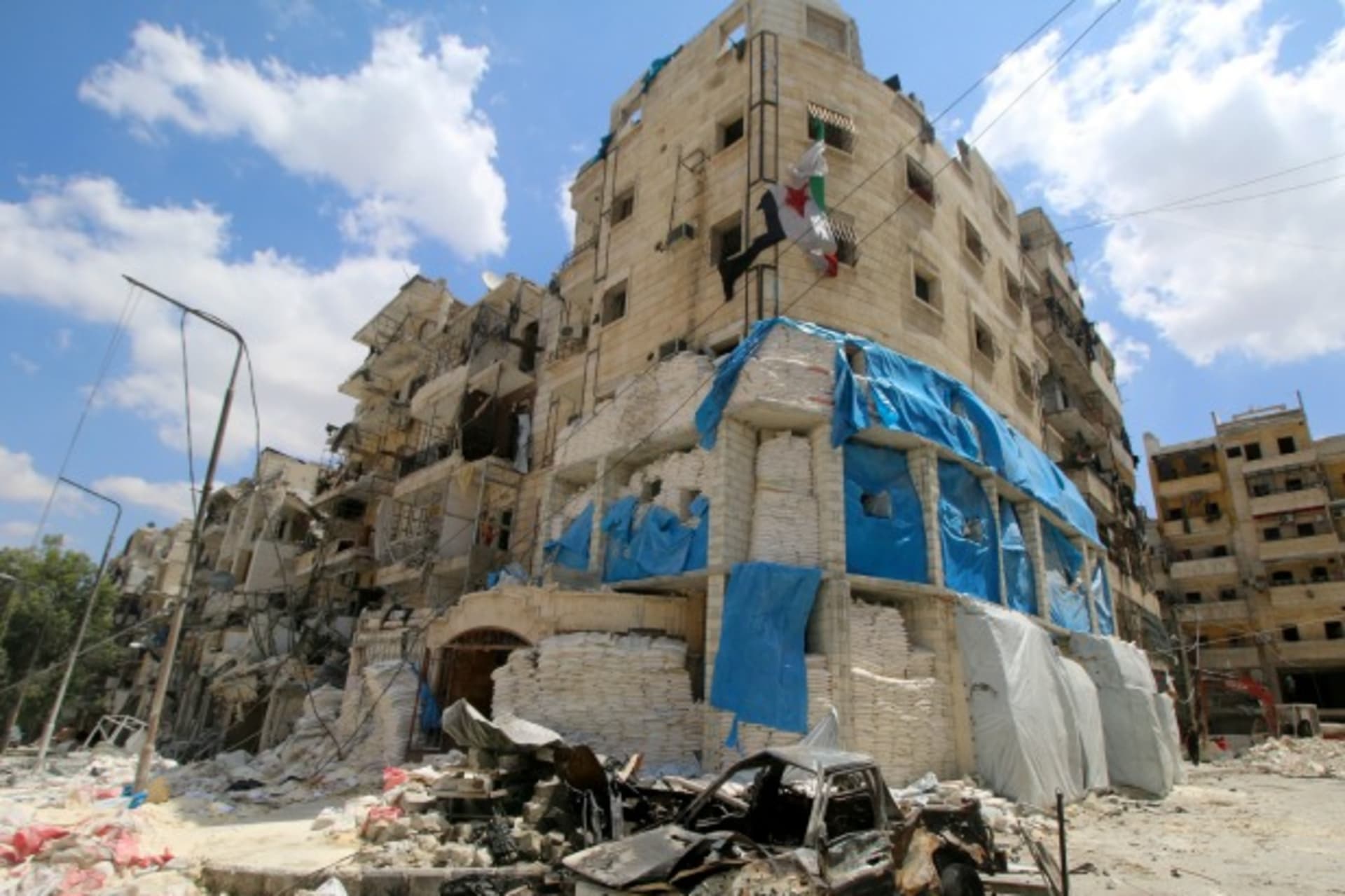 <p>Burnt vehicles are pictured in front of the damaged the Medecins Sans Frontieres (MSF)-backed al-Quds hospital after it was hit by airstrikes, in a rebel-held area of Syria’s Aleppo (Abdalrhman Ismail/Reuters).</p>
