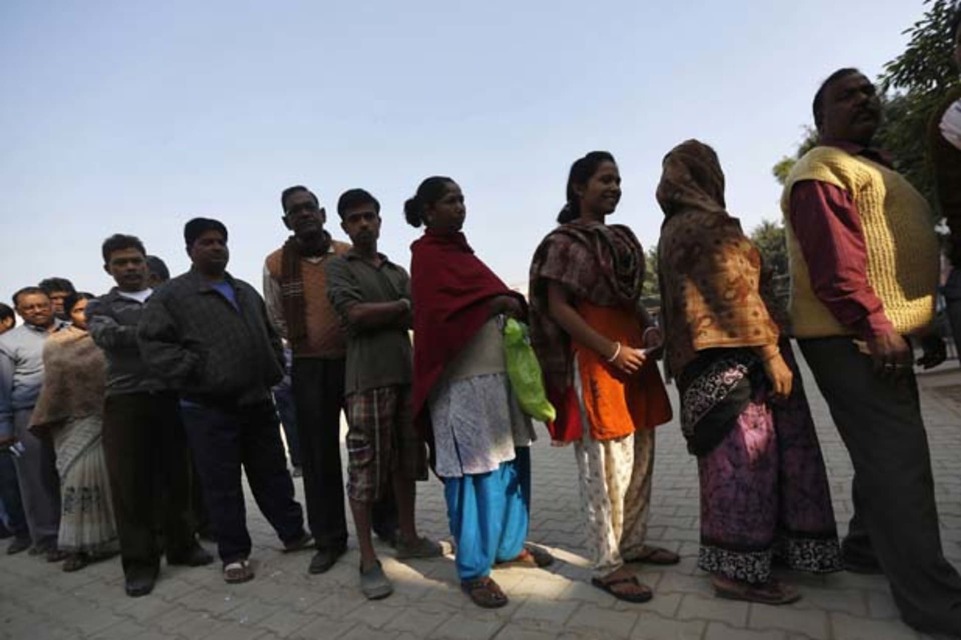 <p>Voters line up outside a polling booth during the state assembly election last week in New Delhi, India. (Ahmad Masood/Courtesy Reuters)</p>
