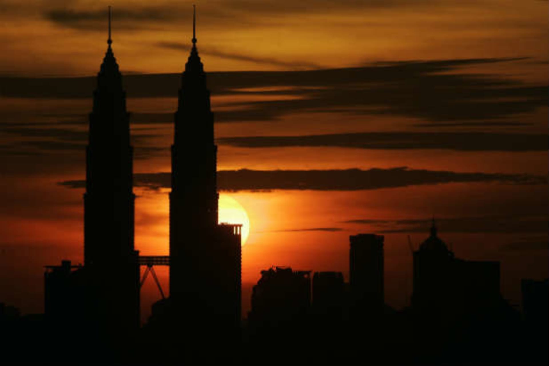 <p>Sun sets over Petronas Twin Towers in Kuala Lumpur (Zainal Abd Halim/Courtesy Reuters)</p>
