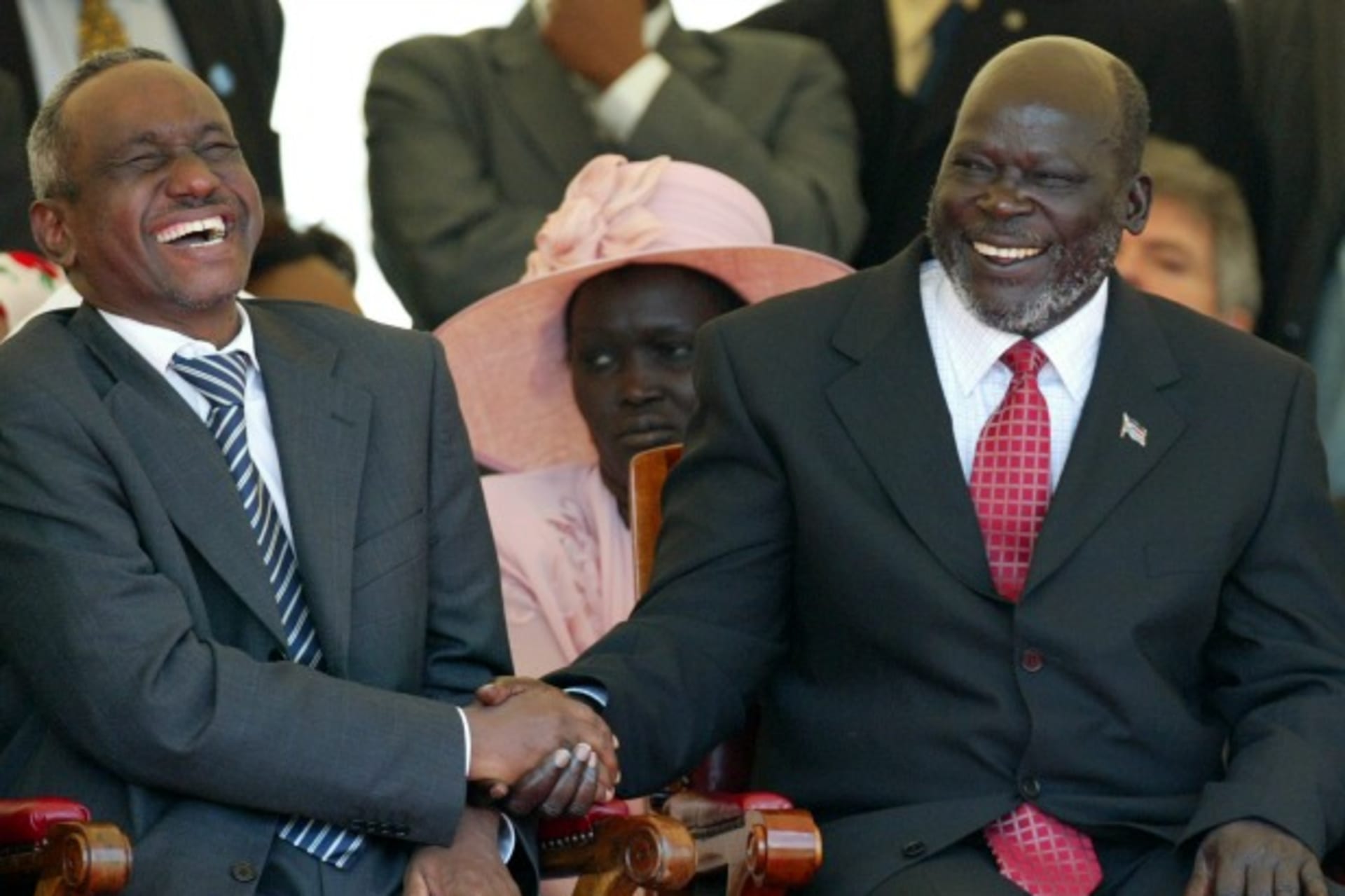 <p>Sudan’s Ali Osman Mohamed Taha and Sudan People’s Liberation Movement leader John Garang laugh before the signing of the Comprehensive Peace Agreement in Kenya’s capital Nairobi, January 9, 2005. (Courtesy REUTERS/Antony Njuguna)</p>

