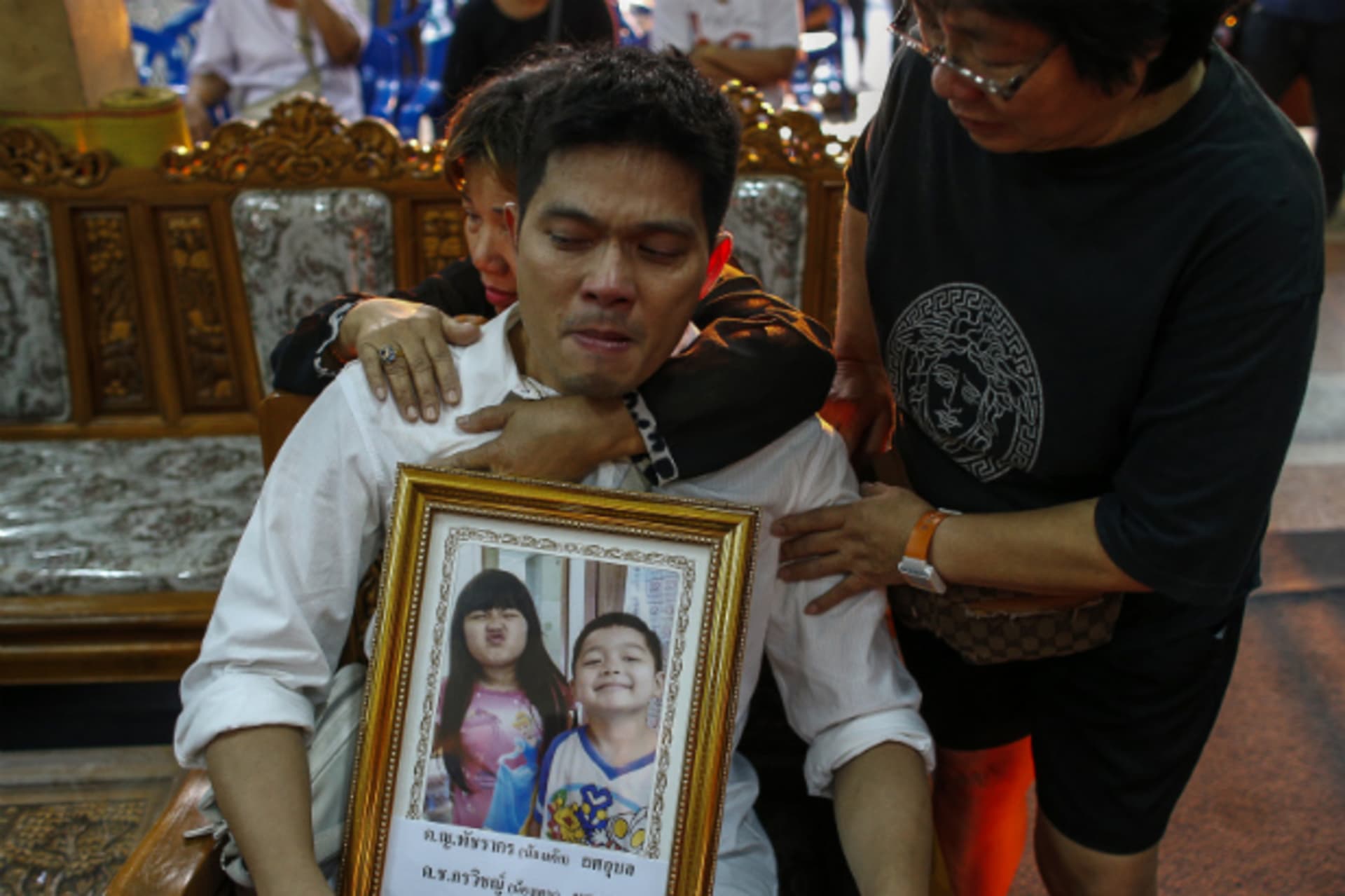 <p>Thayakorn Yosubon, the father of a pair of siblings killed in Sunday’s bomb blast near an anti-government protest site, mourns…his children during their funeral at a Buddhist temple in Bangkok on February 24, 2014. (Athit Perawongmetha/Courtesy Reuters)</p>
