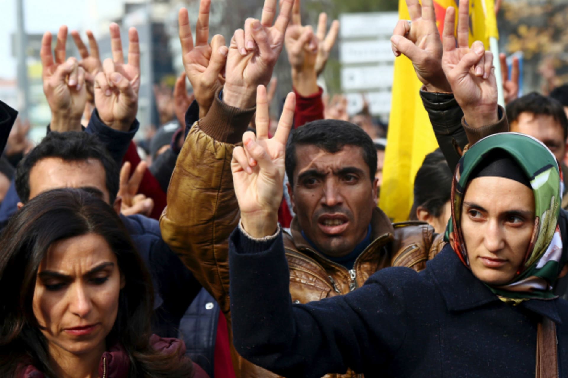 <p>Kurdish demonstrators gesture during a protest against the curfew in Sur district and security operations, in the southeastern city of Diyarbakir, Turkey (Sertac Kayar/Reuters).</p>
