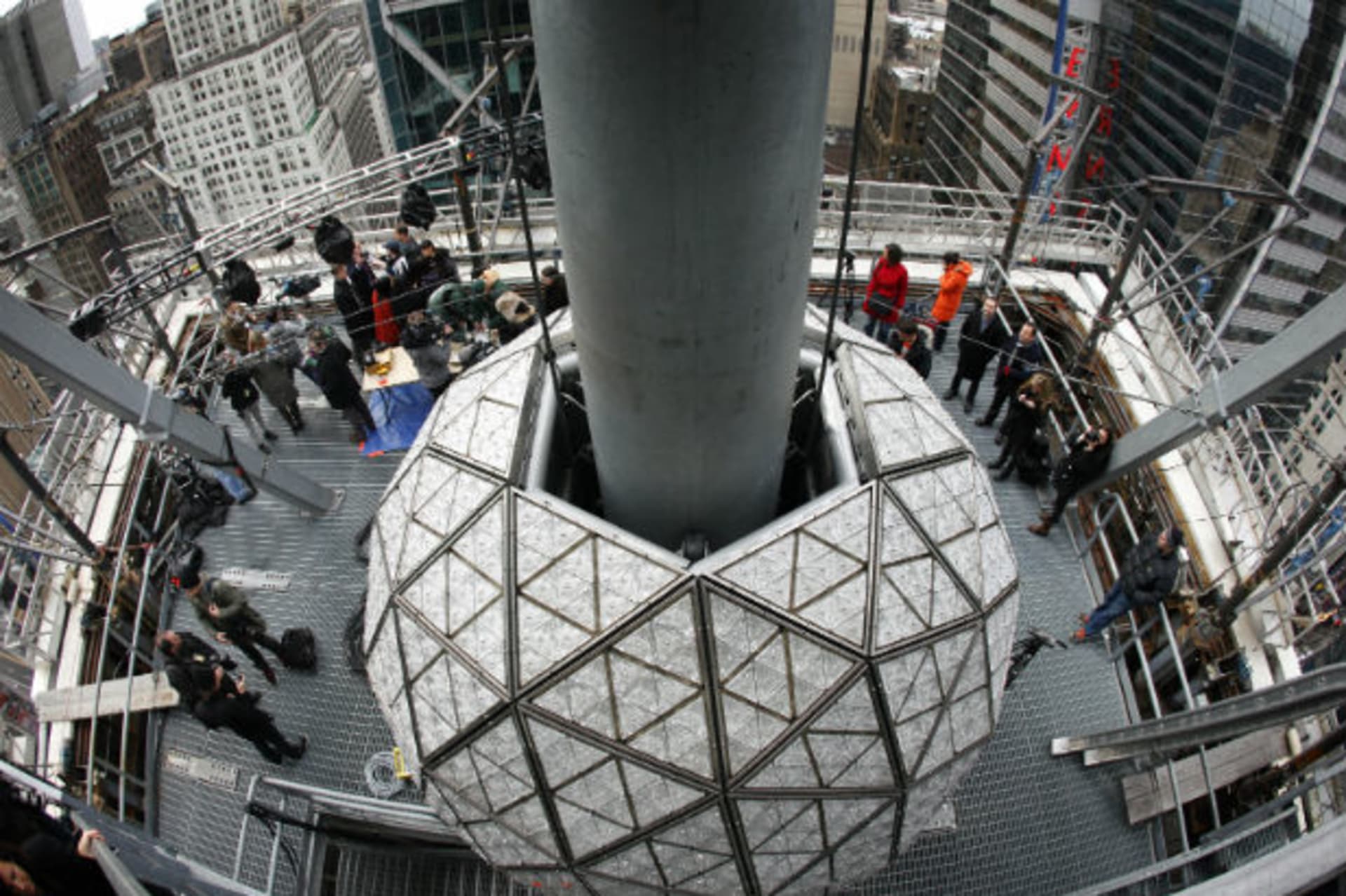 Journalists watch workers install some of the 288 Waterford crystals on the Times Square New Year's Eve Ball in New York (Mike Segar/Courtesy Reuters).