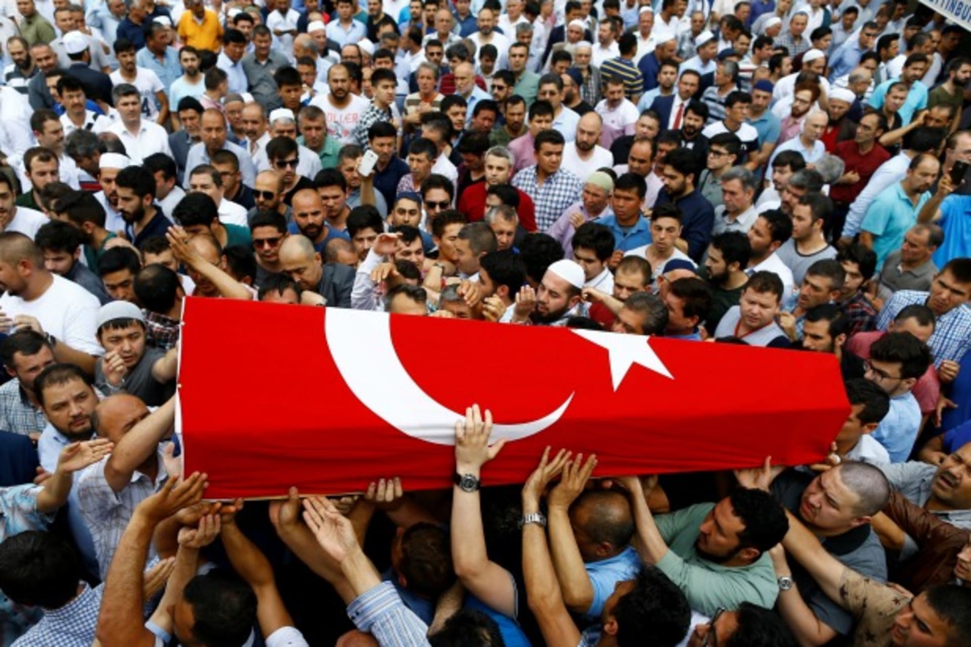<p>Friends and relatives of Habibullah Sefer, who was killed in Tuesday’s attack at Istanbul airport, carry his flag-draped coffin during his funeral ceremony in Istanbul, Turkey (Osman Orsal/Reuters).</p>
