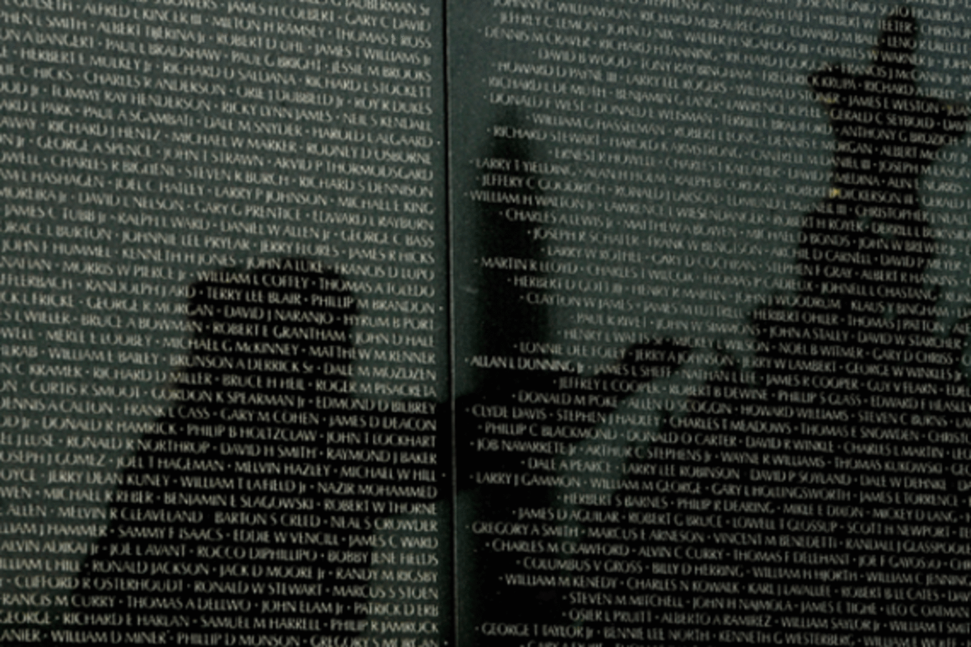 <p>Reflected on the wall listing in the names of American soldiers who died in the Vietnam War, a veteran helps decorate the Christmas tree placed at the Vietnam War Memorial in Washington on December 23, 2008. (Kevin Lamarque/courtesy Reuters)</p>
