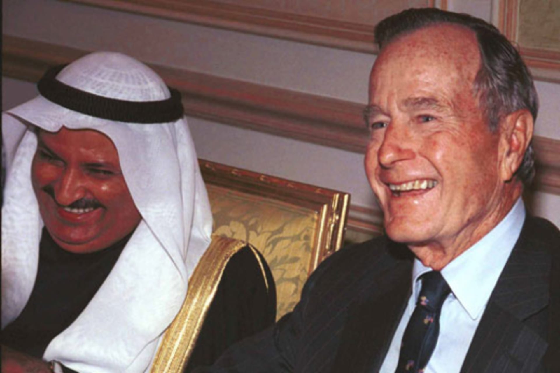 <p>Former President George Bush, visiting Kuwait to mark the country’s tenth Liberation Day, laughs with the Kuwaiti Minister for Cabinet Affairs in February 2001. (Stephanie McGehee/courtesy Reuters)</p>
