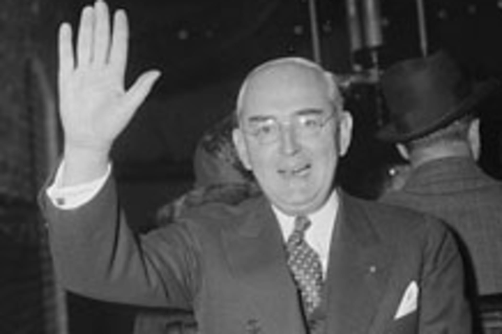 <p>Senator Arthur H. Vandenberg salutes the camera man as he uses the tram for the trip from the Senate Office building to Capitol. (Harris & Ewing/courtesy Library of Congress)</p>
