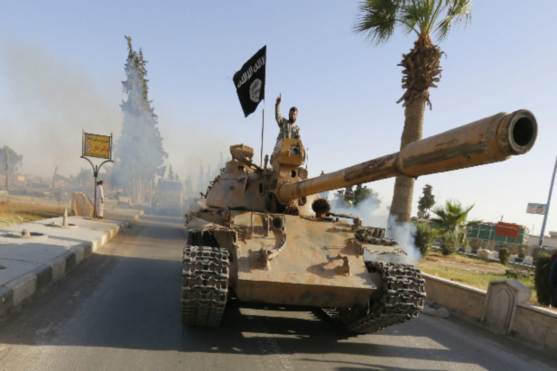 Militant Islamist fighters associated with ISIS  take part in a military parade along the streets of northern Raqqa province June 30, 2014 (Courtesy Reuters).